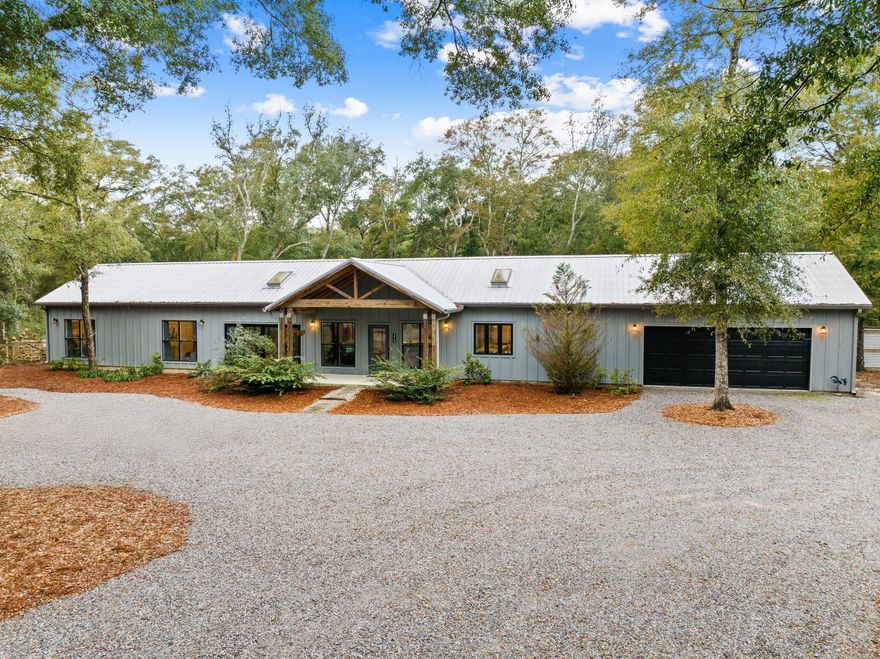 Welcome to Your Dream Estate - A Perfect Blend of Luxury, Functionality & Opportunity Discover a rare opportunity to own a stunning 6.02-acre estate in the peaceful community of Mossy Head. This exceptional property offers the perfect balance of modern design, rustic charm, and commercial potentialideal for homeowners, entrepreneurs, or investors seeking a versatile space.  A Thoughtfully Designed Main Residence Built in 2020, this custom single-story home spans 2,389 square feet, featuring an open-concept layout that seamlessly blends comfort and style. The living room is a showstopper, with its vaulted ceiling and striking wood beam accent, creating an inviting space filled with natural light from expansive windows that frame picturesque views. Entertainer's Dream Kitchen & Dining 
Whether you're hosting intimate dinners or lively gatherings, the spacious dining room accommodates 8-10 guests, with dual sliding glass doors that open effortlessly to the outdoor oasis. The chef-inspired kitchen boasts:  
 A large island for meal prep & casual dining  
 State-of-the-art stainless steel appliances 
 French door refrigerator & wine fridge with wet bar  
 Butler's pantry with double oven for ultimate convenience  

Private Primary Suite & Amenities  
Designed for tranquility, the primary suite offers private pool access through sliding glass doors. The spa-like bathroom features:  
 A walk-in shower & oversized vanity  
 Expansive walk-in closet with a washer and dryer hook up  
 A dedicated dog room with fenced outdoor run, catering to pet lovers  

Guest Accommodations & Versatile Spaces
- Two additional guest bedrooms are privately situated apart from the main home, accessible via a breezeway.  
- A bonus room/home office provides a quiet retreat for work or study.  
- A summer kitchen makes outdoor entertaining effortless.  

Outdoor Living & Endless Possibilities
Step outside to a thoughtfully designed landscape featuring:  
 A privacy fence & gated entry
 A chicken coop & small animal barn with fenced runs  
 A gravel circular drive leading to the main home

Additional Investment & Commercial Potential
A charming guest cottage --a stylishly appointed manufactured single-wide offering comfort and privacy for visitors, in-laws, or flexible living arrangements.  Featuring 3 bedrooms & 2 bathrooms and provides potential rental income opportunity 

This property may be purchased as a whole or sold as 5 parcels, including commercial-zoned parcel, this property offers incredible investment potential. Located near Crestview & DeFuniak Springs, with easy access to Highway 285 for quick commutes to Niceville & Destin, this estate is more than just a homeit's a lifestyle upgrade with limitless possibilities.  

Don't Miss OutSchedule Your Private Tour Today!