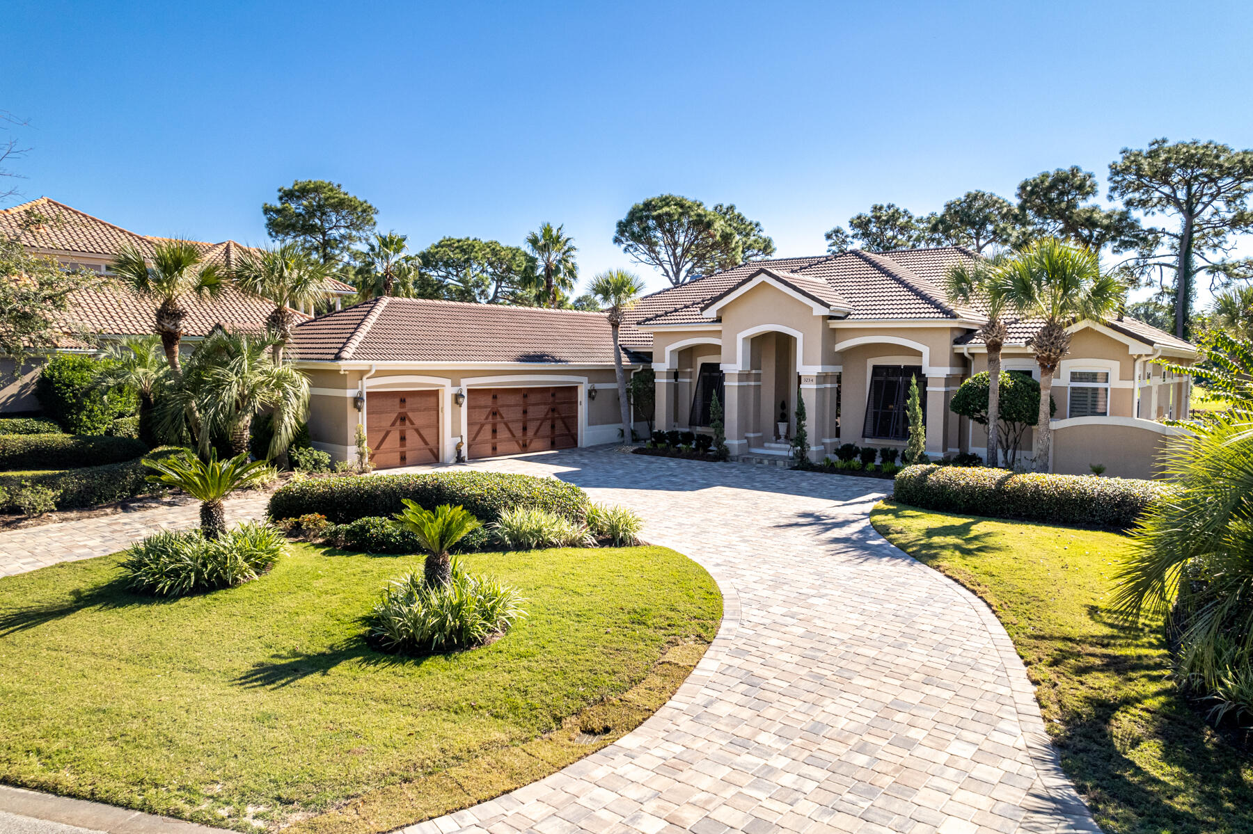 Beautiful one-level home in the prestigious gated community of Burnt Pine in Sandestin. Situated on the 13th fairway, 3234 Bay Estates Drive sits on one of the most desirable streets in all of Sandestin. Measuring 4,589 sq ft, this home features 3 bedrooms plus an office, 4 full baths, additional climate-controlled workout room, chef's kitchen complete with granite countertops and high-end stainless-steel appliances, 2 wet bars with built-in wine coolers, 12 and 14-foot ceilings, crown molding, tile and hardwood floors throughout. Enjoy an additional 608 sq ft of entertaining space in your enclosed 2nd kitchen complete with grilling station, Green Egg, dishwasher, gas fireplace, TV, and built-in 10-person table with gas fire feature.
