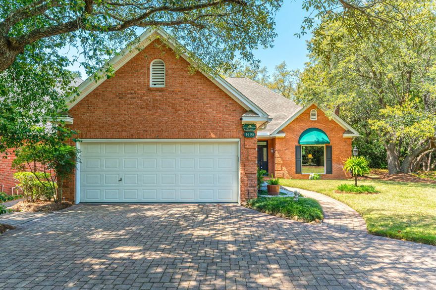LOCATION, LOCATION, LOCATION! Tucked away at the end of a peaceful cul-de-sac in the heart of Bluewater Bay, this beautifully positioned two-story home offers a rare combination of space, privacy, and the lifestyle you've been dreaming of. Located on a large lot directly on the Bluewater Bay golf course, this former spec home was thoughtfully designed with extended dimensions--making it larger than most homes in the neighborhood. As you arrive, a private paver driveway sets the tone for the exclusivity of this property. Step inside to soaring vaulted ceilings and an impressive open layout that welcomes natural light from every angle. The expansive living room flows seamlessly into a formal dining area and a cozy den just off the kitchen--perfect for casual entertaining or  quiet evenings at home.

Whether you're hosting family gatherings, enjoying coffee with a view of the fairway, or riding your golf cart to the nearby marina, tennis courts, or local dining spots, this home offers more than just a place to live. It offers a lifestyle. From peaceful morning strolls under mature trees to sunset rounds of golf and community events, life in Bluewater Bay is all about balance, connection, and comfort. 1498 Oakmont Place is your gateway to it all.