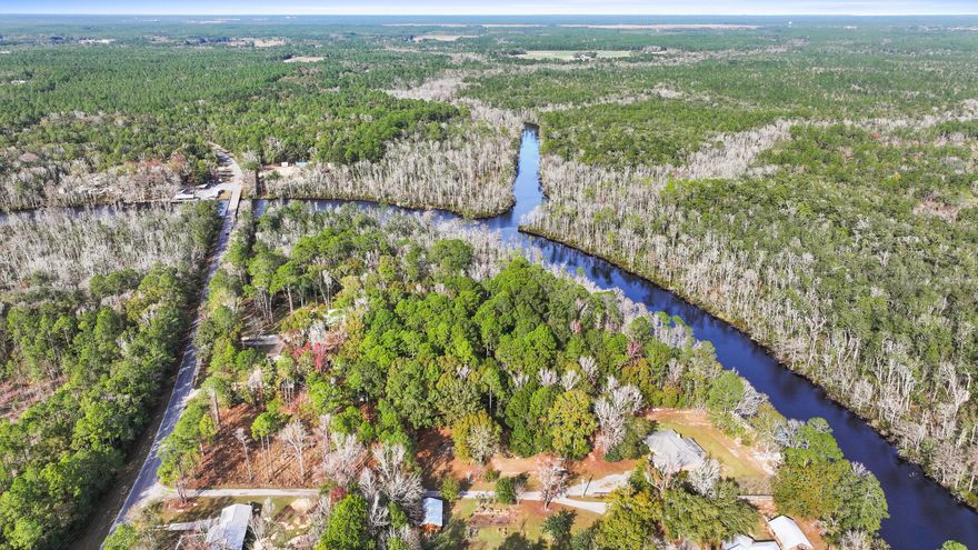 Discover the perfect canvas for your dream home on this expansive one-acre building lot, tucked away from the highway for ultimate privacy. The serene landscape is adorned with majestic southern yellow pine trees, creating a picturesque setting for your envisioned residence. This unique property not only offers the tranquility of private land but also provides an exclusive deeded right of way to Black Creek. Imagine the convenience and pleasure of having direct access to the scenic Black Creek, enhancing your lifestyle with recreational opportunities and natural beauty. With the added perk of permitting RVs and campers, you have the flexibility to enjoy your property while you plan and build your dream home. Embrace the serenity of nature and envision a lifestyle that seamlessly blends comfort and the great outdoors. Seize the opportunity to create your haven in this idyllic 1-acre retreat, where the beauty of nature meets the potential of your dream home. Take the first step towards realizing your vision in this tranquil and inviting property.