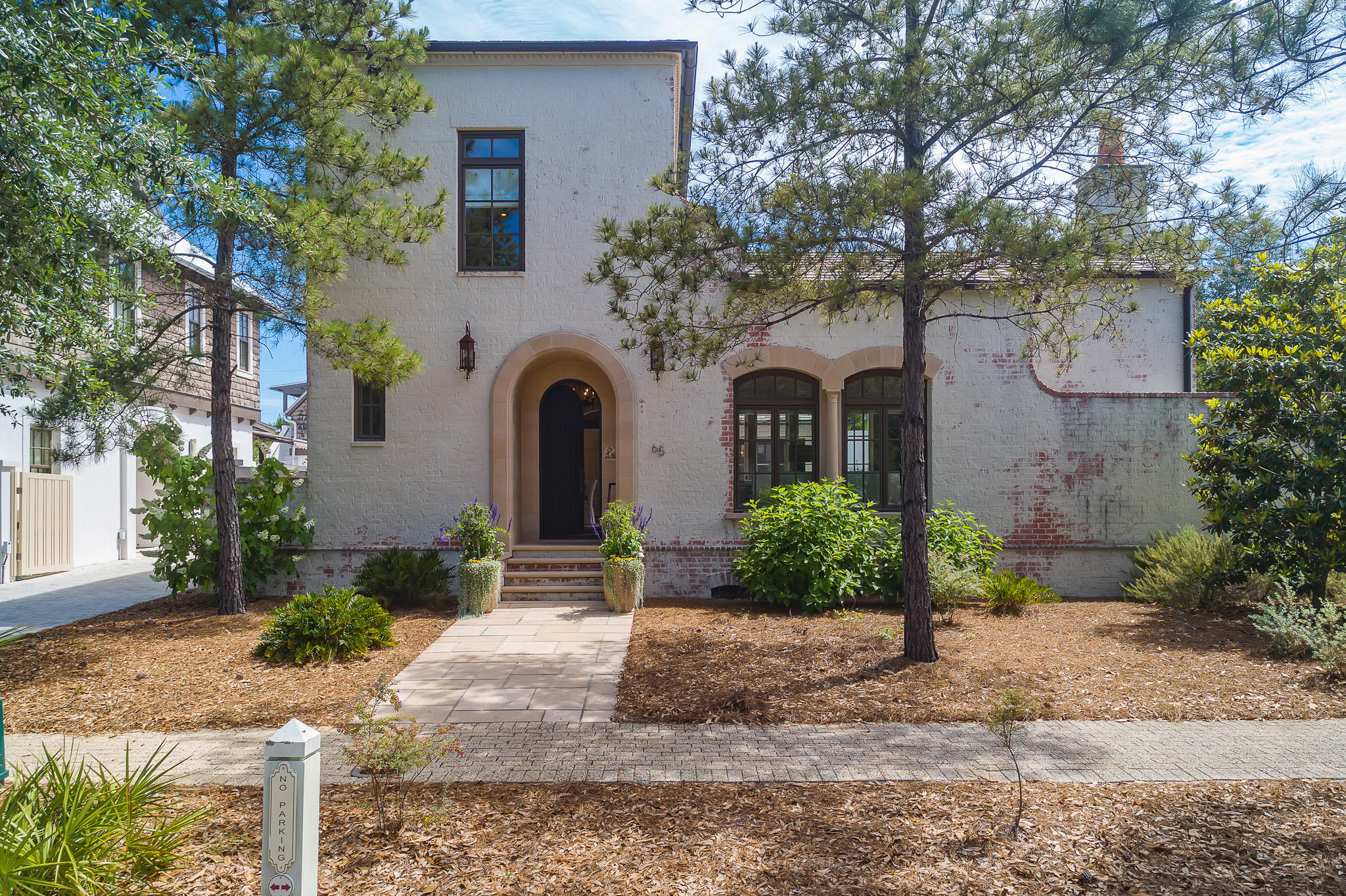 Refined luxury awaits you in this one of a kind Spanish Colonial style home. This exquisite residence is set on an oversized lot just steps away from the Rosemary Beach Owner's Club and Amphitheater. Breathtaking 200 year old rough hewn pine beams and rich antique terracotta tile flooring all grace the first floor. A large open den with 14ft ceilings and marble fireplace leads to an outdoor loggia that overlooks courtyard with private pool. The loggia is complete with custom beams and fireplace. A generous sized kitchen and dining area, is well equipped with shelved pantry, subzero, wolf range, large island with bar seating. Also, located on the first floor is a full sized laundry area and wet bar, with ice maker, wine fridge and custom cabinetry.