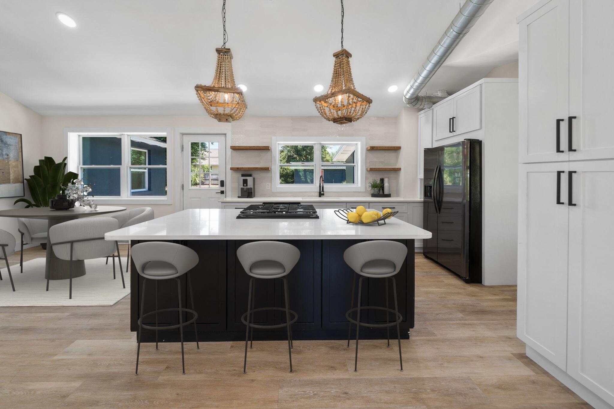 Where modern design meets classic charm, this completely renovated home in the highly sought-after neighborhood of The Cove with NO HOA in Panama City, FL is a stunner! This 1,914 square foot residence has been remastered and was taken down to the studs and fully renovated.Nestled on one of the most desirable streets in Panama City, this home sits on a generous .3-acre homesite, and is adorned with mature oak trees and lush landscaping, creating a serene canvas for years to come. The expansive backyard with a privacy fence provides ample space for a dream pool, summer kitchen, pole barn, or detached garage, with convenient alley access and a large gate for easy parking of a boat or trailer. The home includes a large building with alley access and can be used for storage, a home gym and so much more!
The home is ideally situated across from the water and just around the corner from a public boat ramp, neighborhood parks, and playgrounds. New sidewalks enhance the neighborhood's walkability, and The Cove's location offers a short golf cart drive to downtown Panama City, where boutique shopping, restaurants, and breweries await.
Upon entering, you are greeted by a great room with rare, soaring vaulted ceilings, allowing natural light to flood the space through new energy-efficient windows. The living room features a charming brick fireplace, creating a cozy focal point. The dining room is across from the kitchen creating the perfect great room setup for family gatherings! The spacious kitchen offers a large island, upgraded appliances, quartz countertops, and open shelving adorned with tile extending to the ceiling. Adjacent to the kitchen is a breakfast area with access to a pavered open patio, perfect for outdoor dining and entertaining!
This home includes three bedrooms and two bathrooms. The modern, eclectic primary suite offers a spacious bedroom, built-in designer lighting and a large walk-in closet. The stylish bath gives fun vibes with this unique, stunning tile on the walk-in shower and floor with a charming green vanity and contemporary lighting. The guest bath, accessible from the hallway, features a tiled shower/tub combo with elegant herringbone tile in modern, coastal design and colors!
A unique feature of this home is the inclusion of a mudroom and home office, providing functional space for everyday living and additional square footage that is highly desired in the Cove neighborhood. You'll love having an area for backpacks, shoes and storage when you park in the covered carport attached to the home. The home office offers a retreat for those who like to work from home and desire privacy.
This home combines a prime location with thoughtful, modern renovations and abundant outdoor potential. Don't miss your opportunity to live in the Cove today!
