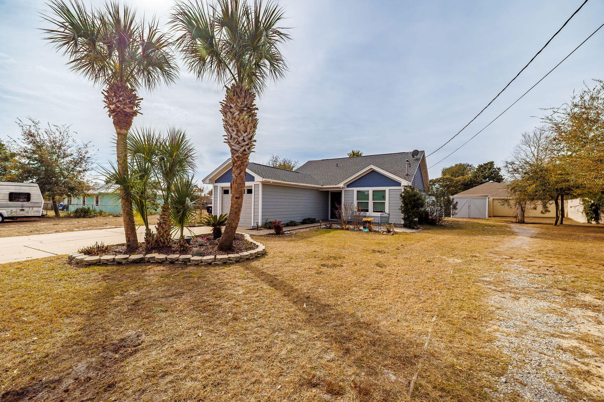 Check out this charming 2 Bed / 2 bath home and development opportunity that is now available! With no HOA dues this property sits in a golf cart friendly neighborhood with close proximity to public beach access, shopping, restaurants, entertainment options, and a public golf course. The floor plan covers 1,020 square feet of heated and cooled space. The kitchen and bar is open to the living space and contains a stainless steel refrigerator and dishwasher. A master and guest bedroom make for comfortable sleeping arrangements for you and your guests. In addition, there is a covered patio and garage with plenty of storage space.  The roof was replaced less than a year ago, and the windows have been upgraded to resist hurricane impact.  This passive income opportunity is zoned R2.