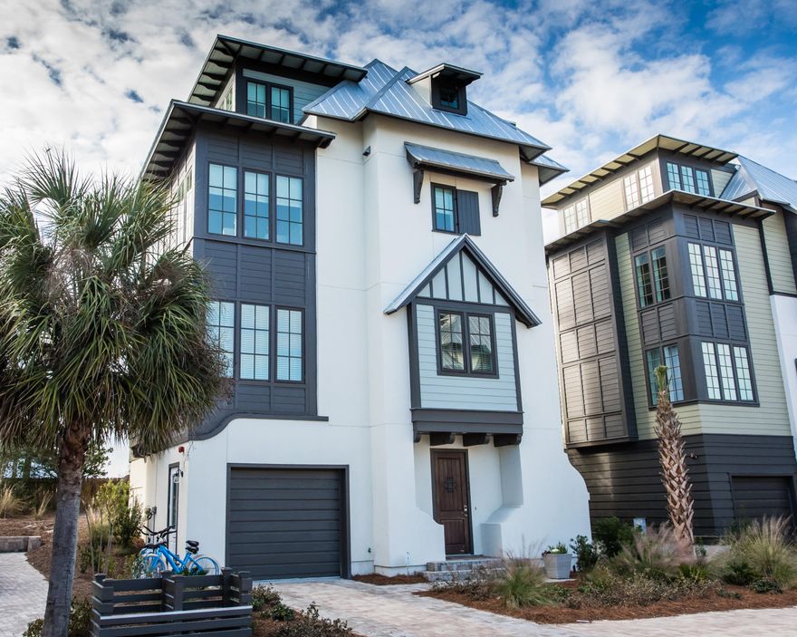 Tresca Place community consist of 9 residences south of 30A in Seagrove. This 5 bedroom 4 1/2 bath with additional bunk room home is only a short walk to the beach. Beautifully appointed,this home features an enclosed garage,residential elevator, large windows,two balconies,and a metal roof.
The living area, which is located on the third floor opens to the kitchen making this a great space for entertaining. The property has been well maintained and shows like a new home.