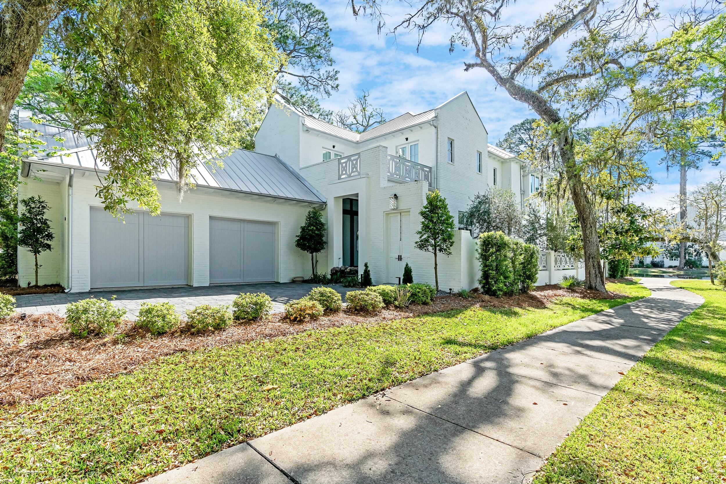 Positioned on a serene, spring-fed lake within the prestigious gates of Churchill Oaks, this stunning custom residence blends timeless Southern architecture with modern luxury. Boasting 4 bedrooms and 4.5 baths, the home offers both first and second-level master suites, catering effortlessly to comfort and convenience.The expansive open-concept layout is designed for both entertaining and everyday living. Anchoring the first floor is an oversized great room featuring a gas fireplace and seamless flow into the dining area, breakfast nook, and gourmet kitchen -- all finished with high-end materials and thoughtful craftsmanship. A private office, powder room, and one of two spacious master suites complete the main level. Upstairs, the primary master suite is a true retreat, accompanied by two additional guest bedrooms. Generous porches on both levels provide tranquil views over the lake, inviting you to relax and unwind in this natural sanctuary.

Outdoors, a charming courtyard with a tranquil water feature offers yet another space to enjoy the lush, native landscape. The adjacent Lot 28 is also available, presenting a rare opportunity to expand your private footprint within this sought-after coastal enclave.

Churchill Oaks is a 40-acre, gated community designed around the beauty of Hogtown Bayou and framed by centuries-old oak trees. With only 87 homesites, it offers an intimate setting rich in amenities, including a deep-water marina with 36 private boat slips, paddleboard storage, fish cleaning station, and shoreline stabilization.

At the heart of the community lies the 8,000-square-foot Clubhouse  an impressive Bayfront facility featuring three pools, a state-of-the-art fitness center, commercial-grade kitchen, outdoor bar, media room, and expansive gathering spaces for owners and guests alike.

This is more than a home  it's a lifestyle defined by coastal elegance and natural beauty. Schedule your private showing today to experience all that Churchill Oaks has to offer.