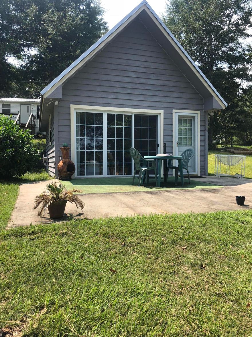 Perfect location for a waterfront weekend getaway, convenient to the Emerald Coast. The 3 bedrooms include a cabin (16' x 24') & a manufactured home (16' x 66'). The dock has been upgraded with stainless steel screws & painted with restore paint. There are 2 septic tanks & 2 electrical boxes, one for each building. Manufactured home is surprisingly spacious with plenty of storage options. Home includes all current furnishings. The cozy cabin has a great view overlooking the property & the lake. It includes a kitchenette & bathroom. Also included is a 2002 32' Landau Motorhome with 20,000 miles. The property is landscaped with fruit trees, blueberry bushes & a lot of greenery. Don't miss out on this opportunity to own a unique property! Make your appointment today to view this oasis!