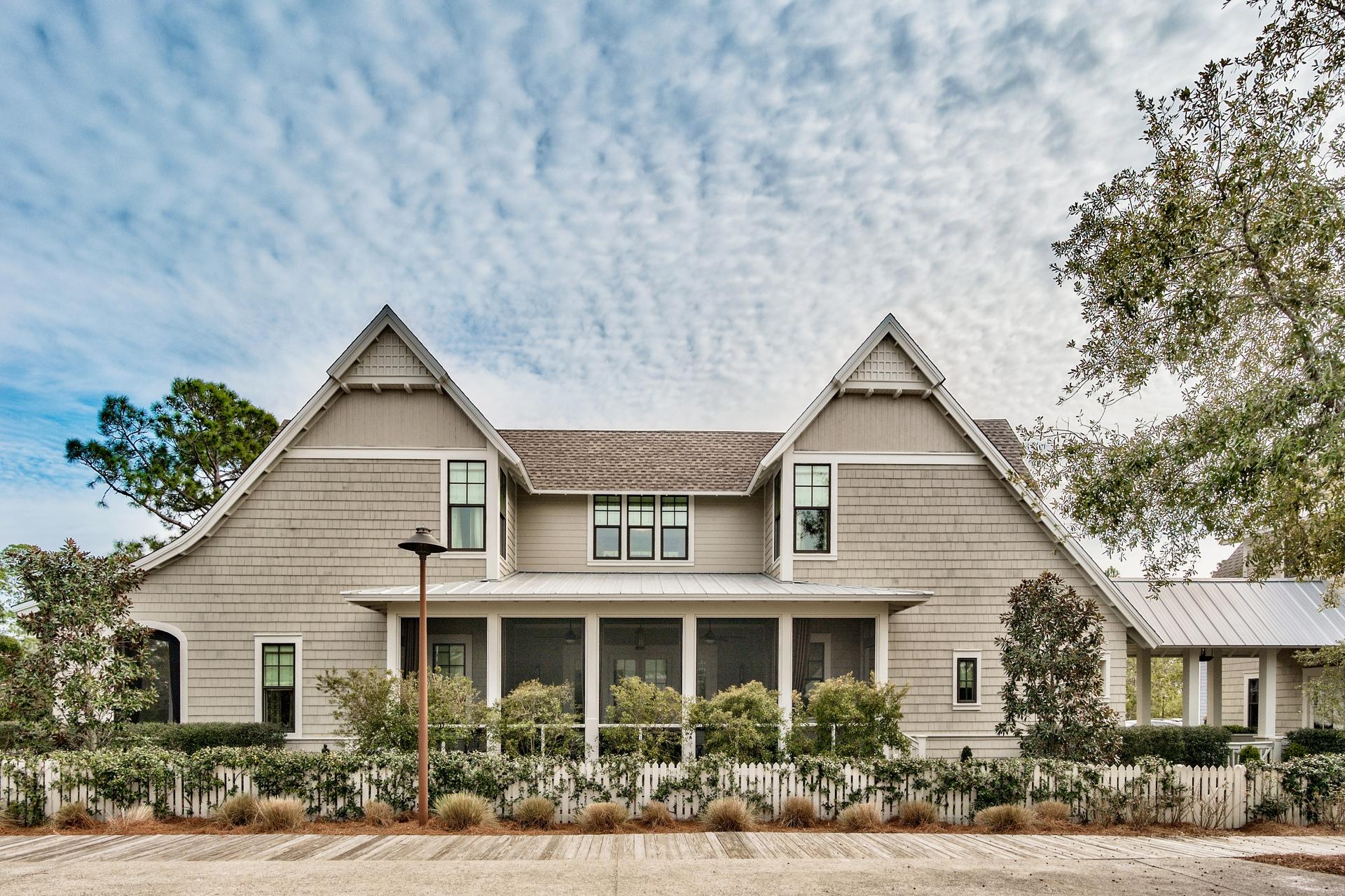 This gorgeous, one of a kind home, offers the most stunning exterior elevation and interior finishes in Watersound West Beach. In this private gated community you will enjoy access to 30A's premier secluded beaches through Deer Lake State Park. The front entrance to the home is just off the boardwalk to the beach & community pool and fronts a large park with trees for privacy. A spacious screened porch leads through french doors to the beautiful great room that is open to the chef's kitchen featuring a commercial sized Viking range, large marble island, and designer Walker Zanger tiles. Entertaining is a dream as the great room flows into the dining hall which features a wine bar with onyx countertops and french doors to yet another spacious screened porch. There is plenty of space for overnight guests as well, as the home boasts a total of five bedrooms, 4 full baths, and a glamorous powder room. The main floor master suite features an ensuite bath with marble encased garden tub, walk-in shower with designer tiles, large linen closet, and two custom "his and hers" walk-in closets. The "hers" closet is very spacious and features an island, custom shelving, and double tier hanging space. This space can easily be converted to additional living area as it has several windows for natural light. On the second level there are three additional bedrooms including a second master suite with ensuite bath, large walk-in closet, and sitting room with TV. A beautiful gathering spot with built-ins, desk area, and sitting area complete the second level. Back on the main level, there is a gorgeous foyer that leads out to the 2-car garage, parking area, and carriage house. The spacious carriage house is perfect for a "man cave", ladies retreat, art studio, or guest cottage as it features a full bath, kitchen area, and plenty of closet space.
This beautiful home is perfectly situated on one of the best lots in the neighborhood and is just steps to the community pool and beach boardwalk. The exterior elevation of the home is just stunning and features an English garden and is beautifully landscaped. Watersound West Beach features a community pool/clubhouse, parks, boardwalks, security/gate, private boardwalk to the beach, and fitness center at Watersound Beach.