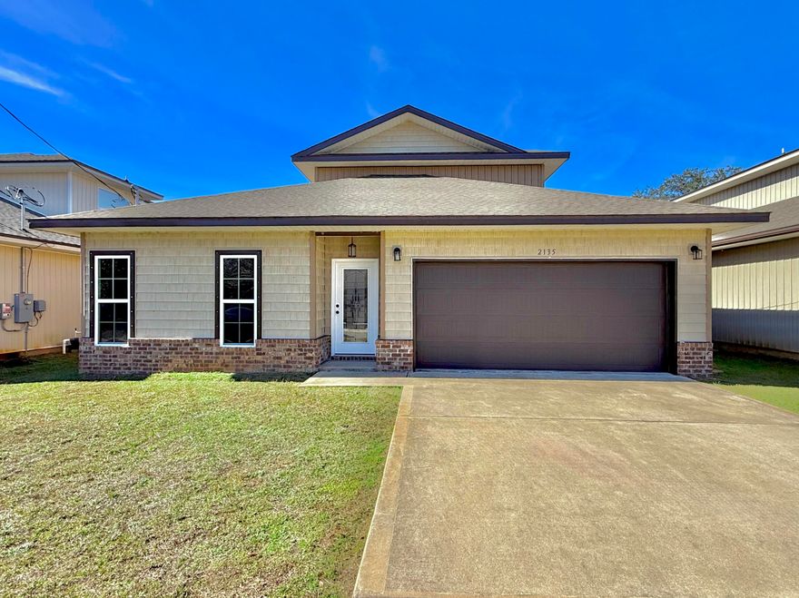 Welcome to 2135 Nina Street, a beautifully crafted modern home built in 2022 and located in a desirable Navarre neighborhood. This spacious two-story residence offers 4 bedrooms, 3 full bathrooms, and just over 2,000 square feet of thoughtfully designed living space, combining comfort, functionality, and contemporary style. The home features an inviting open-concept layout that seamlessly connects the main living areas, making it ideal for both everyday living and entertaining. Natural light fills the space, highlighting clean finishes and a neutral color palette that complements any decor style. The kitchen offers ample cabinetry and counter space, providing a practical and welcoming hub for gatherings and daily routines. The primary suite serves as a relaxing retreat with a private bathroom, while additional bedrooms are generously sized and versatileperfect for guests, a home office, or a growing household. With three full bathrooms, the layout offers added convenience and privacy for everyone.  Outside, the manageable yard provides room to enjoy Florida's outdoor lifestyle with minimal upkeep. An attached garage adds functionality and storage, while the home's location offers easy access to schools, shopping, dining, and the beautiful white-sand beaches Navarre is known for.  Move-in ready and modern throughout, 2135 Nina Street is an excellent opportunity to enjoy comfortable living in a thriving coastal community.