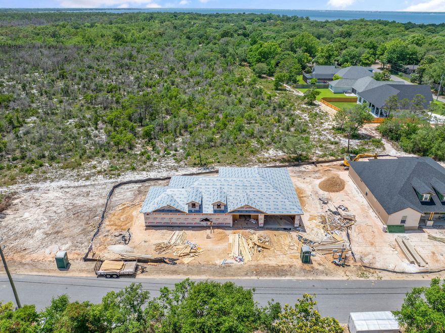 A Custom Home in Gulf Breeze That's Anything But OrdinaryTucked into the tranquil beauty of Gulf Breeze, a new custom home is nearing completion -- and it's not just another house on a lot. This one-acre slice of paradise, shaped like a generous slice of pizza, is the perfect balance of privacy, space, and convenience. Best of all? No HOA to tell you how to live.Nature at Your Back DoorSurrounded by serene woodlands, this property offers peace and privacy with wooded views to the south -- land that is fully yours. Whether you're a nature lover or simply enjoy a quiet escape, this backyard retreat gives you room to breathe. Want to build a pool? Park an RV? Store your toys, trailers, or camper? There's space -- and then some. An oversized driveway ensures there's plenty of room for it all.

Designed for Living Well

Inside, the home boasts four large bedrooms  two of which can serve as full master suites, perfect for multi-generational living or hosting guests in style. The layout is as functional as it is spacious, with thoughtful design throughout.

You'll enjoy the efficiency and reliability of all-gas appliances, plus a tankless gas water heater that delivers endless hot water and lower energy bills. A brand new septic system keeps your monthly water costs minimal, and a full irrigation system fed by a private well supports lush landscaping that will soon bring this yard to life.

Nearly Finished, Perfect Timing

As of May 15th, this home is approximately 20% complete just in time for a mid to late July move-in. Whether you're relocating or upgrading, now is your chance to secure a home that offers both convenience and seclusion. Located just minutes from the beach, top-rated schools, and shopping, you'll have everything you need without sacrificing privacy.

Don't Miss Out

If you've been dreaming of a custom home with room to roam, surrounded by nature, and located in beautiful Gulf Breeze  this is the one. With no HOA, plenty of space, and the final touches just weeks away, your perfect summer move is waiting.

Ready to take a tour? Come walk the property, explore the woods to the south, and envision life in your very own slice of Gulf Breeze.