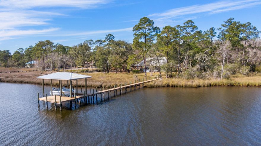 Two combined parcels totaling more than 2.5 acres, with 130 feet on deepwater Lagrange Bayou, and with a new dock and covered boatlift. The setting is very private, at the end of a cul de sac, down a long gravel drive, with nesting eagles on the creek to the north. The house has been completely transformed, one project at a time, by the current owners since they bought it in 2016. Their care and workmanship are apparent. Come see for yourself. The master bedroom on the ground floor has views of the Bay, a huge walk-in closet with built-ins, and a newly renovated en suite bathroom with quartz double vanity and subway tile shower. Recently installed luxury vinyl plank flooring throughout the first floor. Carpet in the upstairs bedrooms and landing.... There is a large room downstairs with its own outside entrance that is currently used as an office but could be a fourth bedroom. Lots of storage in this house, including a unique cypress-paneled storage room off the fourth bedroom. There is an oversized garage/workshop, two AC systems, a fence side yard for pets. Washer and dryer, three refrigerators and a freezer convey with the sale.