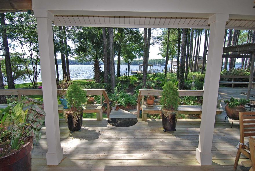 DREAMS ARE MADE OF THIS! Absolutely stunning home with sensational bayou & bay views! Situated on a huge, private & well-landscaped lot with pines, oaks and magnolia's. The entire home has been renovated with new hardie plank siding & hurricane resistant windows. As you enter the property, one is immediately impressed by the long private paver, lushly landscaped driveway leading to the house. Upon entering, is a large open living area with a travertine fireplace, with great views of the beautiful water & dock in the backyard. This large 4 bedroom, 3.5 bath home has a modern, contemporary kitchen with stainless appliances and granite, with great views of the bay & bayou. The large first floor master opens to an outdoor deck & Jacuzzi. The master bath has a huge shower and gorgeous