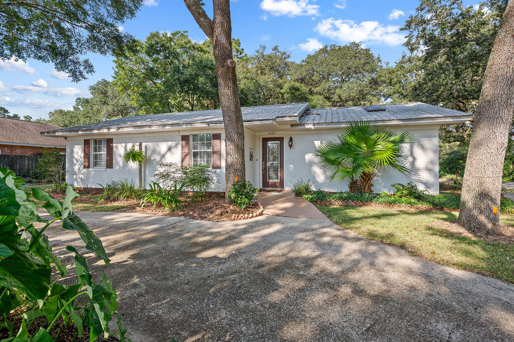 Charming 3-Bedroom Home with Bonus Living Area and Outdoor Retreat This well-maintained one-owner home offers three bedrooms, two full baths, and 1,350 square feet of living space. In addition, there is a heated and cooled 672-square-foot bedroom/flex area and a half bath located in/above the garage, providing excellent flexibility for a home office, guest suite, potential rental opportunity, or recreation area.The home is cozy and the living area features vaulted ceilings and wood flooring, and the interior has been freshly painted. The property is nearly half an acre and includes a treed backyard designed for both relaxation and entertaining. There is plenty of shade and an outdoor cooking pavilion with a built-in gas grill, a firepit, table/eating area, garden boxes, irrigation with a well pump, and a mostly privacy-fenced yard.
Practical features include RV parking with electric and sewer connections, a circle driveway, and a durable metal roof, and a brand new water heater. The property also comes with an active, transferrable treat-and-repair termite bond and one-year Home Warranty for peace of mind.
Conveniently located near beaches, shopping, and military bases, this home combines comfort, functionality, and outdoor living in the heart of Niceville.
Schedule your tour today.