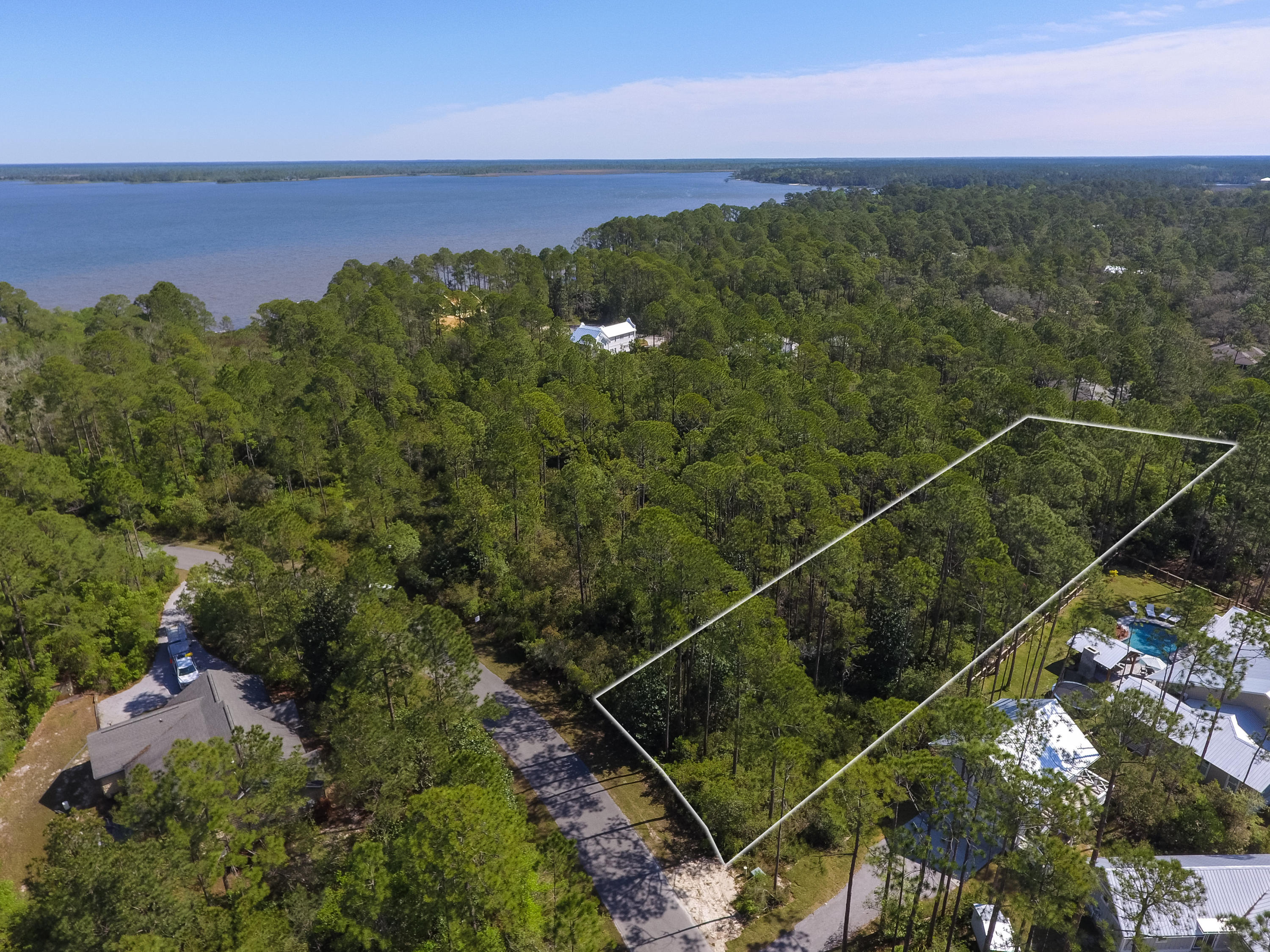 Build your dream home on this .76 acre lot in this quaint waterfront community in Point Washington. The Woods is a carefully planned, serene and wooded neighborhood with a community dock, community park with benches, picnic tables and nature trails. Neighborhood path leads through trees out into a grass area and ends at a dock on the Bay with beautiful views. This is an excellent quiet community with permanent owners. The Woods is located close to the beach, bay, Sacred Heart Hospital, restaurants, GREAT SCHOOLS and shopping! Lots this size are hard to come by and wont last long! Don't miss out on this one!
