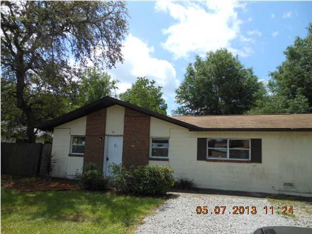 Great Opportunity. 3-bedroom home with a distinct possibility of creating a 4th bedroom. Home currently has 3 living areas, one of which can easily become that 4th bedroom. The largest living area includes a corner bar...perfect for entertaining! Wood laminate in the living room; tile throughout the rest of the home. Property also features a screened back patio, a large yard building, and a back gate accessing the street behind. This property is being sold ''as is'', the seller warrantees nothing. Buyer to verify all facts deemed important to them about this property.
