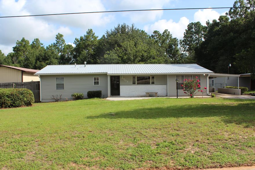Don't let the age of this home fool you~ In the heart of town, this 4 Bedroom, 2 1/2 Bath with above ground pool and large deck has a very large kitchen, living room, large family room and sits on a large corner lot~ It has a large carport for the RV and a nice shop~ The back yard is fenced~ This is ready to move in~ Close to schools, Churches & shopping~ There is an attached carport, detached carport and garage and shop, small playhouse and large RV carport~ The back yard is fenced with double entry gate on side~