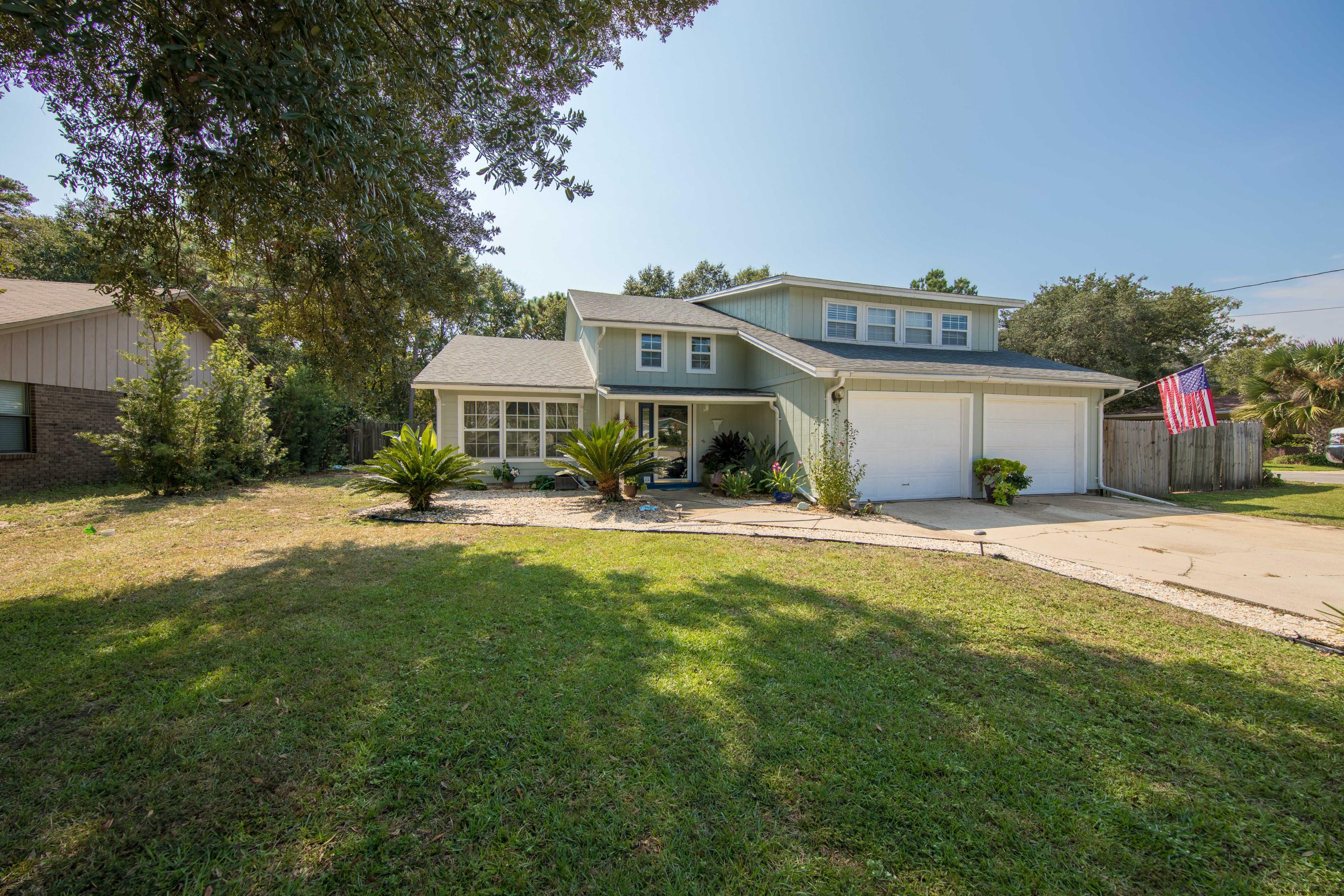 Beautifully landscaped, two story home on a corner lot in a great neighborhood;centrally located to military bases, shopping, schools and Cinco Bayou boat ramp.This home is Move In ready with an open concept coastal inspired interior,updated kitchen, new flooring, and built in shelving on the fireplace wall. It hasfour bedrooms (two master suites), 2- -1/2 baths, a large office / study and a Floridaroom. The backyard is an oasis with a pool, patio and covered seating area. The two cargarage, storage shed, and fenced side yard for RV or boat storage complete thislovely family home. Features:Recessed Lighting - Copper Wiring - TV Wall Mounts - Vaulted Ceiling - Lots of counter space and cupboards - French Doors - New Electric Fireplace - Newer appliances: stainless dishwasher