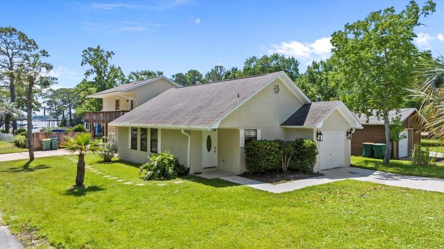 VA-qualified buyer may assume the Seller's 2.625% VA loan! ~$1,925 total monthly pmtBeautiful WATER-VIEW home located in the heart of Niceville features 4 bedrooms and 3 baths!The kitchen offers excellent sight-lines into the living and dining room and boasts limestone countertops and backsplash, a breakfast bar, and stainless steel appliances. Enjoy the scenic water view from the 2nd floor back deck.The primary bedroom features a wrap-around porch offering additional views of the bayou; En-suite bathroom with granite countertop and a jetted tub. Generously sized closet with ample shelving throughout.The home also includes 3 additional bedrooms and 2 bathrooms, providing plenty of space for family and guests.Additionally, this home includes two single garages and a fenced yard