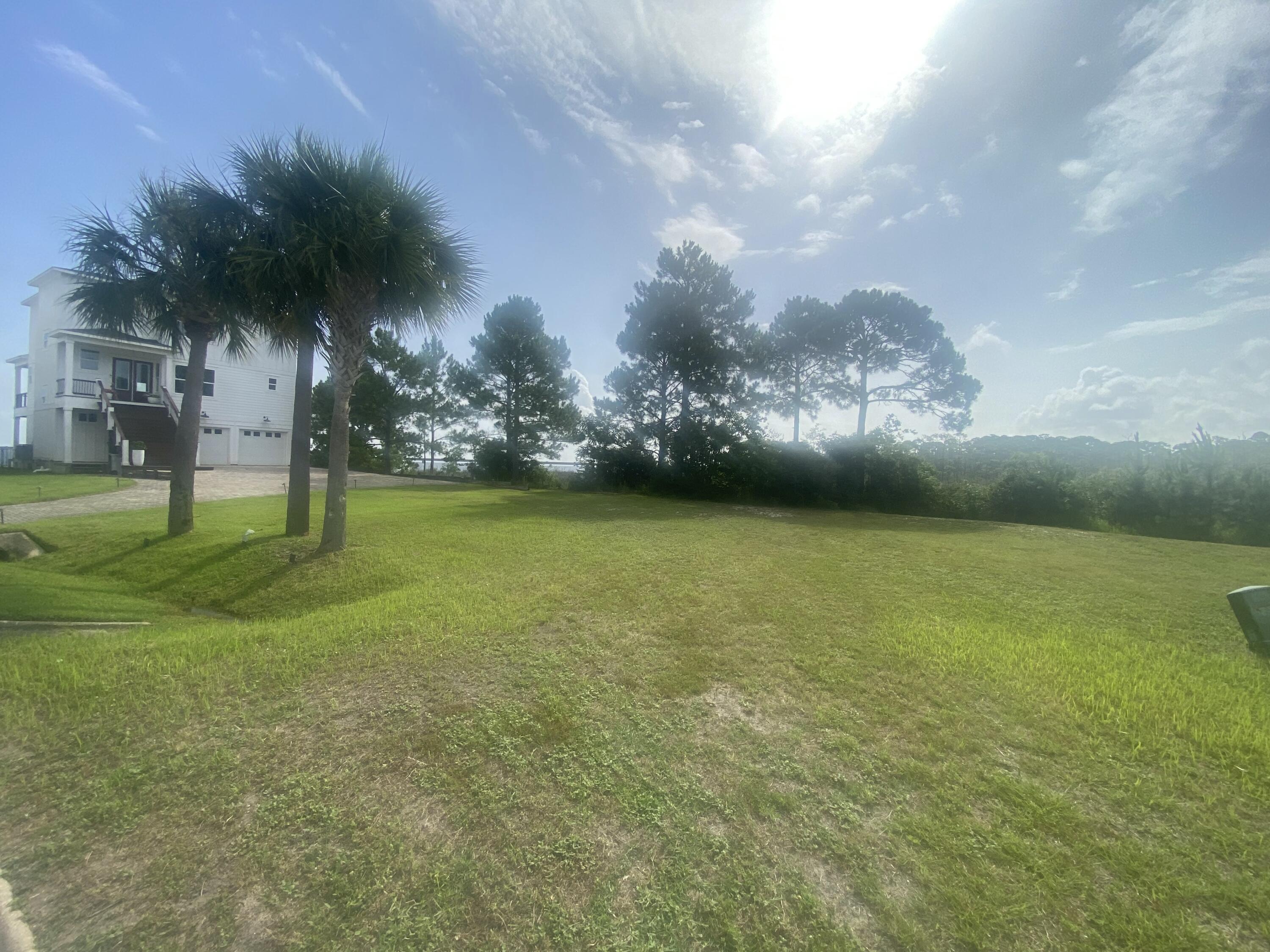 Nestled in the serene, gated community of Clipper Bay, this vacant lot offers a rare chance to craft your ideal home in a location that combines privacy, stunning views, and over 65' of waterfront on the bay, perfect for water enthusiasts who dream of kayaking, paddleboarding, or simply relaxing by the water. This lot is ready to go with water connection, sewer tap & power. The lot boasts expansive views over picturesque marshland, creating a peaceful and natural backdrop for your future home. Revel in panoramic vistas of two iconic landmarks--the Garcon Point Bridge and the Three Mile Bridge. This lot offers flexibility in design while maintaining a generous space to incorporate outdoor living areas, gardens, or other personal touches. Come see it today!