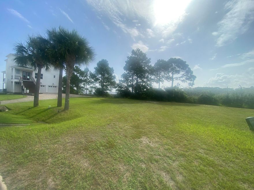 Nestled in the serene, gated community of Clipper Bay, this vacant lot offers a rare chance to craft your ideal home in a location that combines privacy, stunning views, and over 65' of waterfront on the bay, perfect for water enthusiasts who dream of kayaking, paddleboarding, or simply relaxing by the water.  This lot is ready to go with water connection, sewer tap & power. The lot boasts expansive views over picturesque marshland, creating a peaceful and natural backdrop for your future home.  Revel in panoramic vistas of two iconic landmarks--the Garcon Point Bridge and the Three Mile Bridge.  This lot offers flexibility in design while maintaining a generous space to incorporate outdoor living areas, gardens, or other personal touches.  Come see it today!