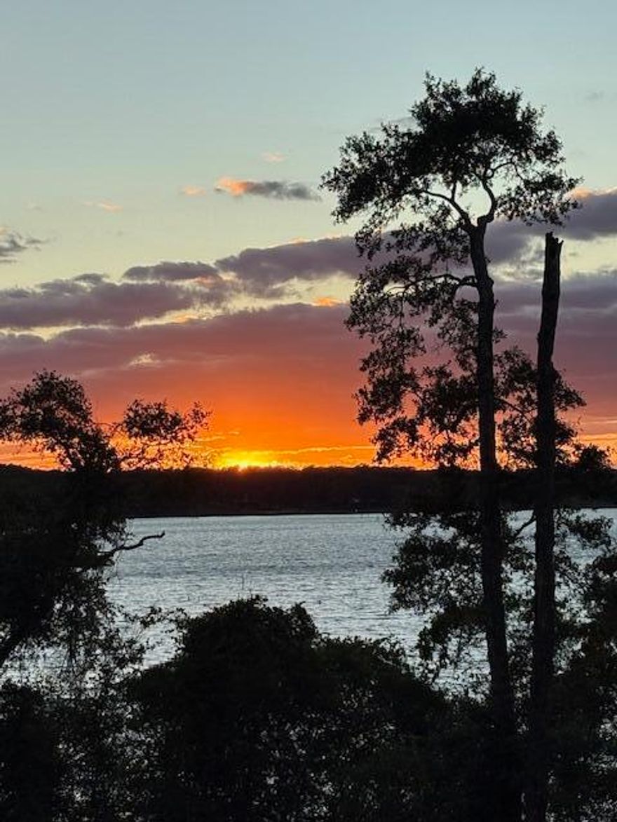 Seacoast Estates is the newest gated, waterfront subdivision in the area. With hills and live oaks lining the freshly paved roads, it's something special. Two separate lakes afford views from all directions. Little Lake Holley is approximately 50 acres in size and Lake Holley is approximately 250 acres in size! Each lake has a boat ramp too. Every lot in Seacoast Estates is waterfront, with water access and potential for a dock. Lot 56 is located on the POINT and elevated above it all. The boat ramp is right there. The views from this lot are fantastic! This lot is super private however it feels like you are on top of the world. Definitely worth taking the time to see. The under ground utilities are complete, so grab your plans and get building!