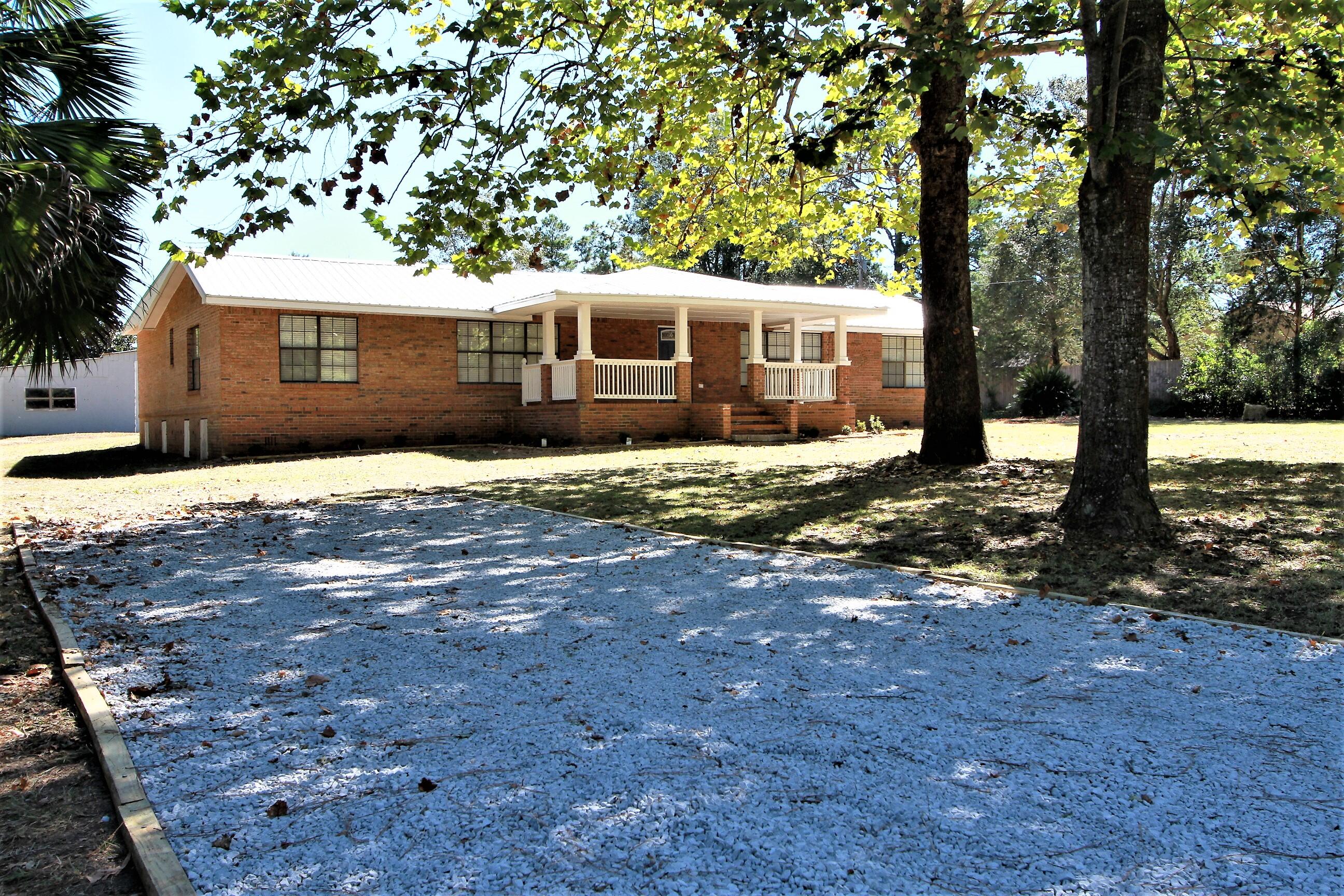 HOME HAS NOT BEEN LIVED IN SINCE RENOVATION. NO HOA SO NO RESTRICTIONS! Beautifully RENOVATED BRICK HOME ON 1 ACRE PARCEL WITH 5 CAR DETACHED GARAGE, CARPORT & GREEN HOUSE. Country Living so why not change the Green house into a CHICKEN COOP. New Metal Roof, Electrical, plumbing in 2020 . Large Covered Front Porch to catch the Florida Breezes. Beautiful Maple Tree in front yard along with various trees but mostly cleared and level. Home Boasts an Open concept Living room that leads into the Beautifully renovated kitchen and dining room. Kitchen has quartz Counter Tops with backsplash, plenty of cabinet space and Brand-New Stainless-Steel appliances. 4 Bed 2 Bath with Large Master Suite and Large Master Bath. Separate Soaking Tub, walk in shower along with His and Her sinks.