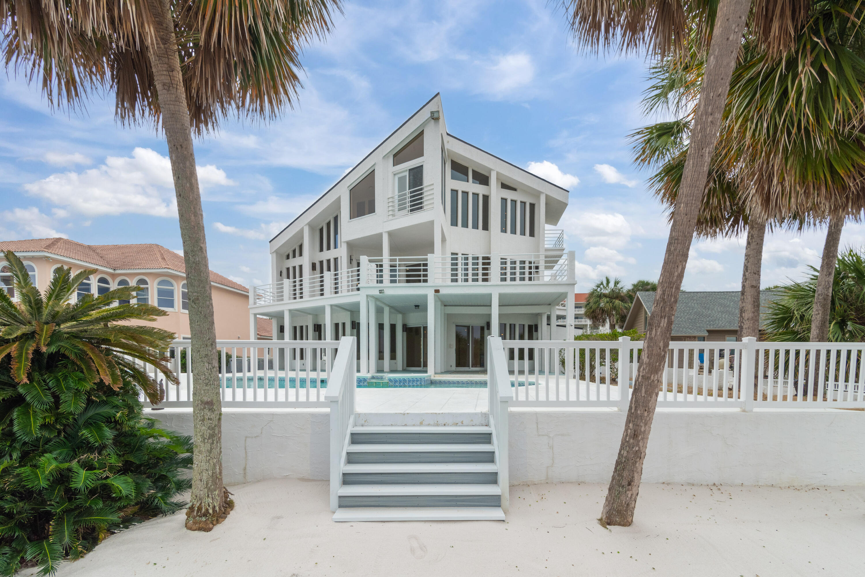 TRULY ONE OF A KIND! Positioned at the End of Okaloosa Island, this property boasts unobstructed western views of the Gulf of Mexico and Intracoastal waterway. IMPRESSIVE 3 Story Contemporary Estate with 2021 New Dimensional Roof w/warranty & New 2021 HVAC w/warranty. Home features central Spiral Staircase, 4 Bedrooms, consisting of 2 Master Suites, one on 2nd Floor and larger of the 2 takes up the entire 3rd Floor with Fireplace in Master, 2 Bedrooms on First Floor. 2 Kitchens, 2 Laundry Rooms. 2nd Floor Large Great Room with Fireplace, Bar and Dining Area. Large Patio overlooks Pool & Deep Water Access with Plenty of Room for a BIG BOAT, Dock has 2 Boat Lifts & 2 Wave runner Lifts, plus you can walk across the street to the Beach.