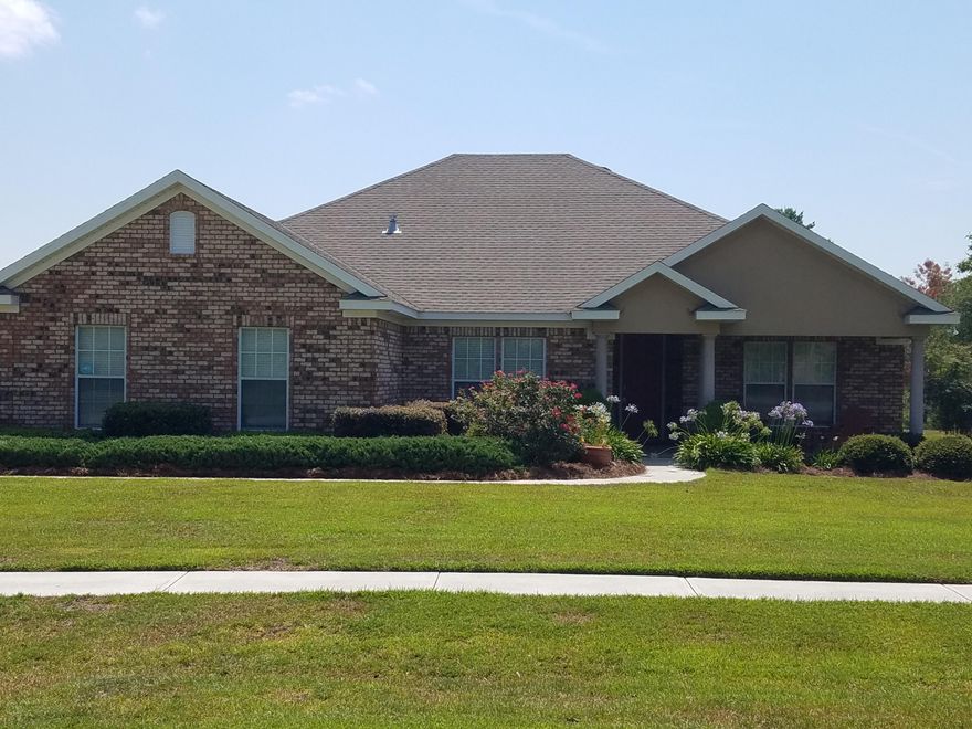 All brick custom quality home built in 2006 on 3/4 acre, directly on Windswept Dunes golf course. Wood flooring in main living and in large kitchen with island, great for entertaining. Expansive cabinet space with custom wood cabinets and granite counter tops in kitchen and all baths. Large great room overlooking private back yard. Screened porch in back with stone laid patio. Owners have taken pride in ownership and have maintained the home in excellent condition. Large master bedroom with oversized master bath, tub and separate shower, double sink vanity and large walk in closet. Split bedroom plan with large bedrooms. Side entry garage with epoxy garage floor. Alarm system, lush landscaping. Neighborhood has golf, tennis and community pool.