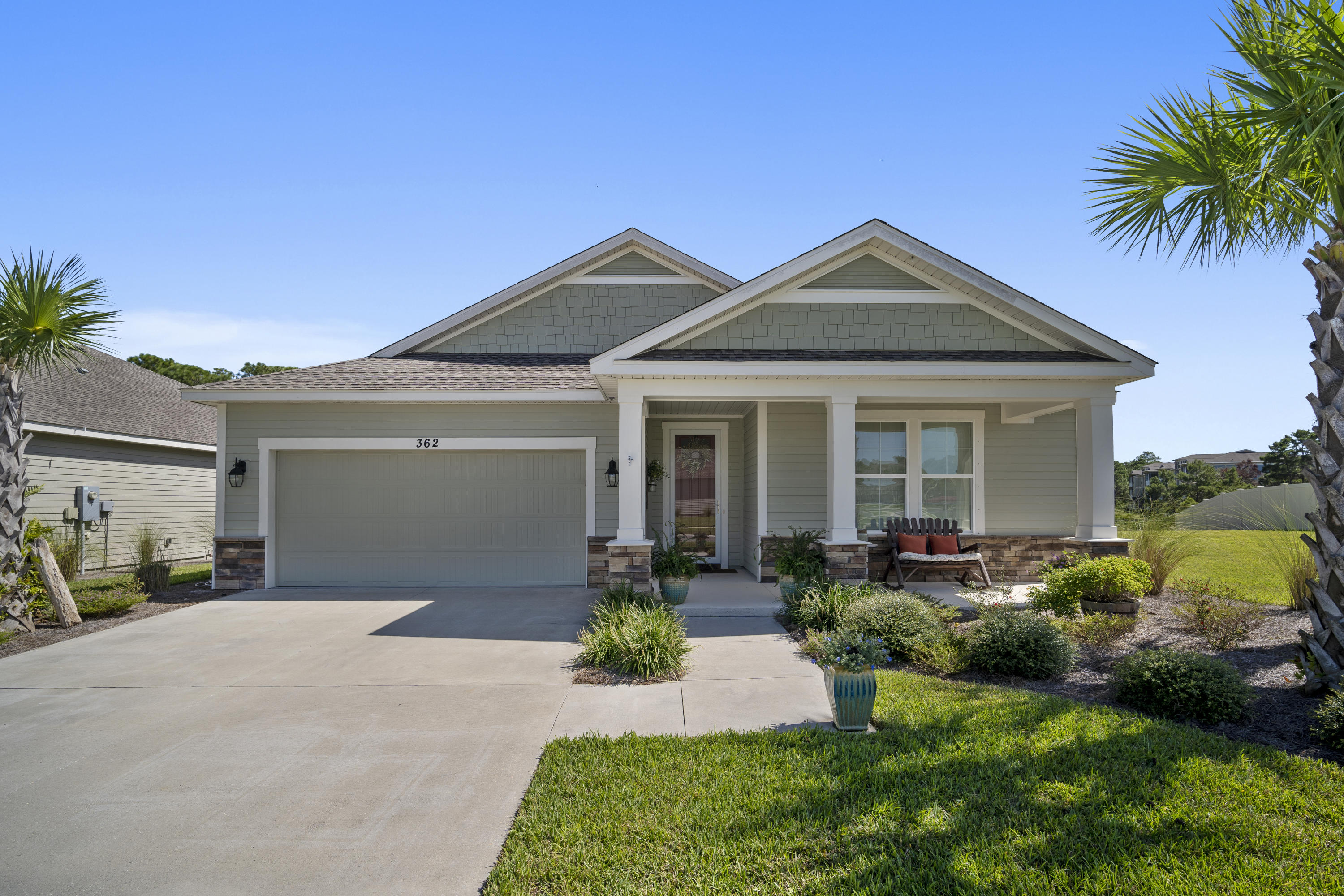 This beautiful Coastal Craftsman-style home located on the highly desirable West end of the beach will take your breath away! The 1800 SF interior exceeds expectations with its tasteful crown molding, modern luxury laminate flooring, and custom window treatments throughout. The open floor plan boasts a large kitchen with granite counters, SS appliances, plenty of cabinets with under counter lighting and upgraded back splash. The large master features a walk in closet, master bath with double vanities, a glass walk in super shower with pebble stone flooring. Beautiful french doors flow seamlessly from the elegant living area into the screened porch. Love to entertain? Invite guests out on the brick paver extended patio to grill, relax and to enjoy the pond view, star gazing or more