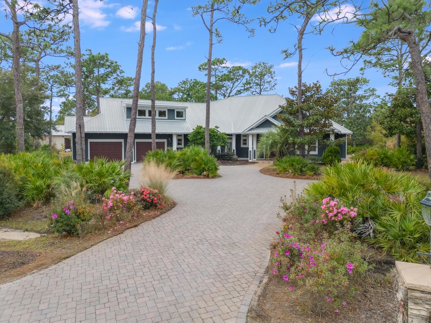 Fusing comfort and functionality, this custom-built residence offers the perfect balance of backyard living and elegant design sensibility. Sprawling over a .75-acre lakefront estate-sized lot, projecting a remarkable curb appeal in the highly desirable Woodland Bayou neighborhood, this property is ideally positioned only a few minutes between the beautiful 30A beaches and the Bay. The impressive custom sinker cypress door welcomes you to the foyer where you will take note of the beautiful hardwood floors, 12ft ceilings, designer light fixtures and crown molding, which are featured throughout the home.