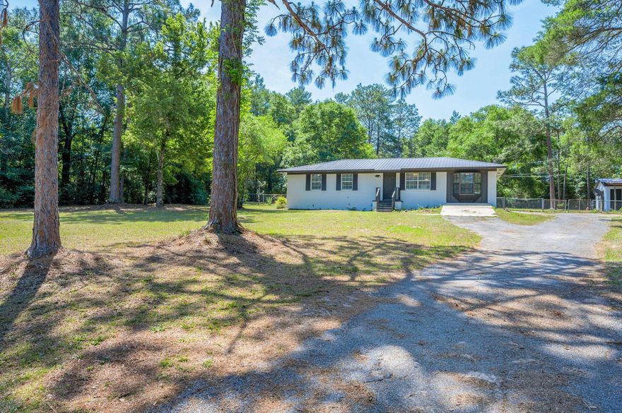 FULL ACRE LOT....and a 4 BD/3 BA home that's had numerous renovations! Beautiful vinyl plank flooring (in all areas w/ exception of kitchen/dining area and bathrooms), fresh paint throughout and new light fixtures to name a few. The home features a semi-open floor plan. Kitchen boasts white cabinets, new countertops and new stainless/black appliances. The home has a split bedroom floor plan. The backyard is fenced in and there's a workshop/garage w/ power as well. Nice property with a country feel but not too far to town.