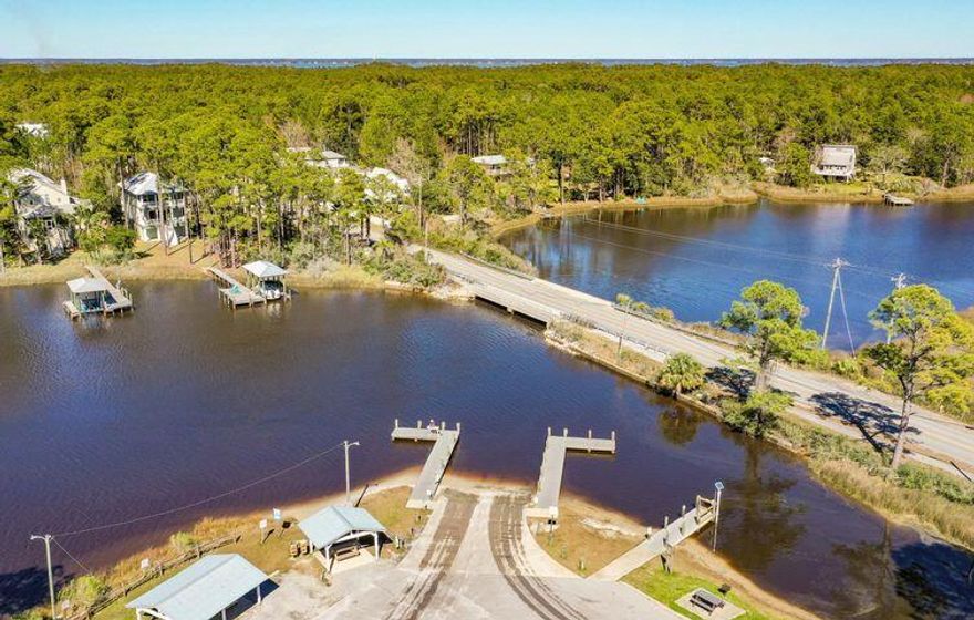 Double lot with a 3 bedroom, 2 full bath double wide trailer with strong rental history. Fantastic opportunity to build 2 homes on these lots in the future. Easily accessible to Cessna Landing boat launch. So much potential for this lot all within 10 minutes to the beautiful beaches of 30a!