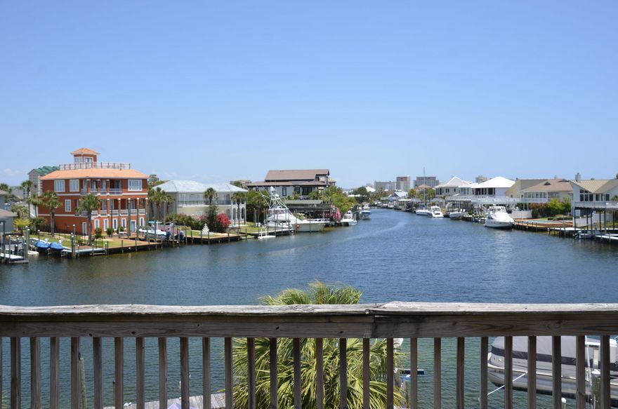 Ready to live the Destin life  all you need to bring is your toothbrush and your swimsuit. Welcome to 165 Durango, a beautiful, well-maintained, fully furnished waterfront town home located on a canal just off the Destin Harbor. Dock your boat at your backdoor. The boat lift is only 5 years old and can hold a boat up to 28 ft or 7,000 lbs. The owners say one of their favorite things to do is to watch the parade of boats come in after a fun day on the water. The water view is to the east which gives you ample sun in the cooler part of the day and shade in the afternoons when you really need it. Each floor has either a balcony or deck space so you can catch the view from multiple levels. Improvements include a new roof in 2019 and new HVAC in 2018. CLICK ''MORE'' FOR ADDITIONAL IN The living area and kitchen are situated on the second floor and boast custom concrete flooring. There is also a half bathroom on the second floor which is very convenient for your guests. Two of the bedrooms are located on the third floor, each with access to a full bathroom. The master bedroom features a private balcony with an amazing view of the water.  The master bathroom has tile flooring, a spacious vanity, and walk-in closet.  The bonus space behind the garage has been converted into an additional bedroom with its own private bathroom with laundry hook-up.  There is also private access to the back deck from this room.  This townhome complex has no Homeowners Association (HOA) so there are no monthly fees.  The owners say that they enjoy evening cocktails with their neighbors who are all very nice.  An additional bonus is the extra parking across the street for when you need it.  Whether you are using this as a primary, secondary or investment property, this one is sure to please!  PLEASE NOTE:  Artwork will not convey.