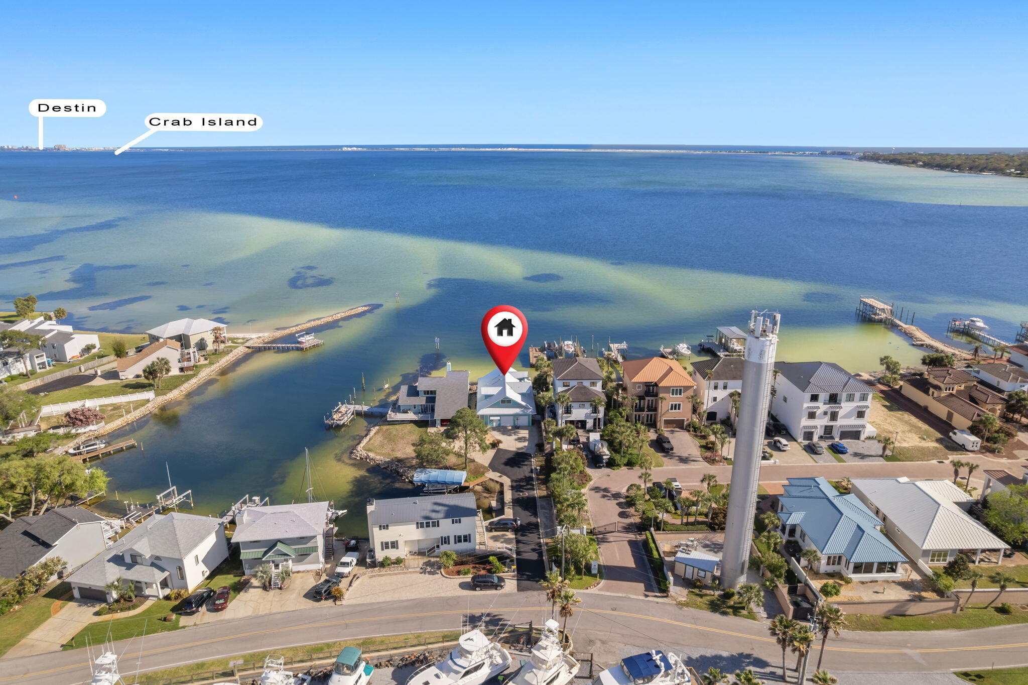 Welcome to 101 Starboard Lane, a beautiful waterfront home in the sought after area of Bal Harbour in Shalimar, FL. The private dock is a standout feature, complete with a protective cover, a 10,000-pound boat lift and nestled in a cove for extra protection. Experience stunning panoramic views of Choctawhatchee Bay and Okaloosa Island/Destin, with Crab Island just a short 15-minute boat ride away, and Norriego Point Beach and the Destin Harbor only 20 minutes by boat. You'll have easy access to a variety of waterfront restaurants and bars along the Destin Harbor, as well as being able to enjoy breathtaking sunsets and watch dolphins parade right from your backyard, deck, dining room, living room and master bedroom! In the backyard, water access into the bay is available via stairs in the rock seawall, and the piling foundation offers massive storage space under the home. This property boasts a brand-new metal roof installed in 2023, ensuring durability and peace of mind. The home is equipped with newly replaced HVAC systems, with the downstairs unit replaced in 2019 and the upstairs unit in 2022, along with a hot water heater updated in 2020. The kitchen is a chef's dream, featuring a large island, granite countertops, a professional-grade 48" Thermador gas stove with six burners and a double oven, dual full-sized sinks, and plenty of natural and recessed lighting. An oversized pantry provides ample storage space. The master suite offers wide waterfront views, multiple closets, and a standalone shower. All first-floor bedrooms come with their own bathrooms, providing convenience and privacy. The spacious laundry room includes storage cabinets, a sink, and counter space for added functionality. The oversized garage is a versatile space, featuring a full bathroom and a walk-in storage closet. On the second floor, you'll find an expansive living room with stunning waterfront views and abundant natural light perfect for private space or an entertaining game room, a guest bedroom with a full bathroom, and a wet bar with storage. Call us for your private tour!