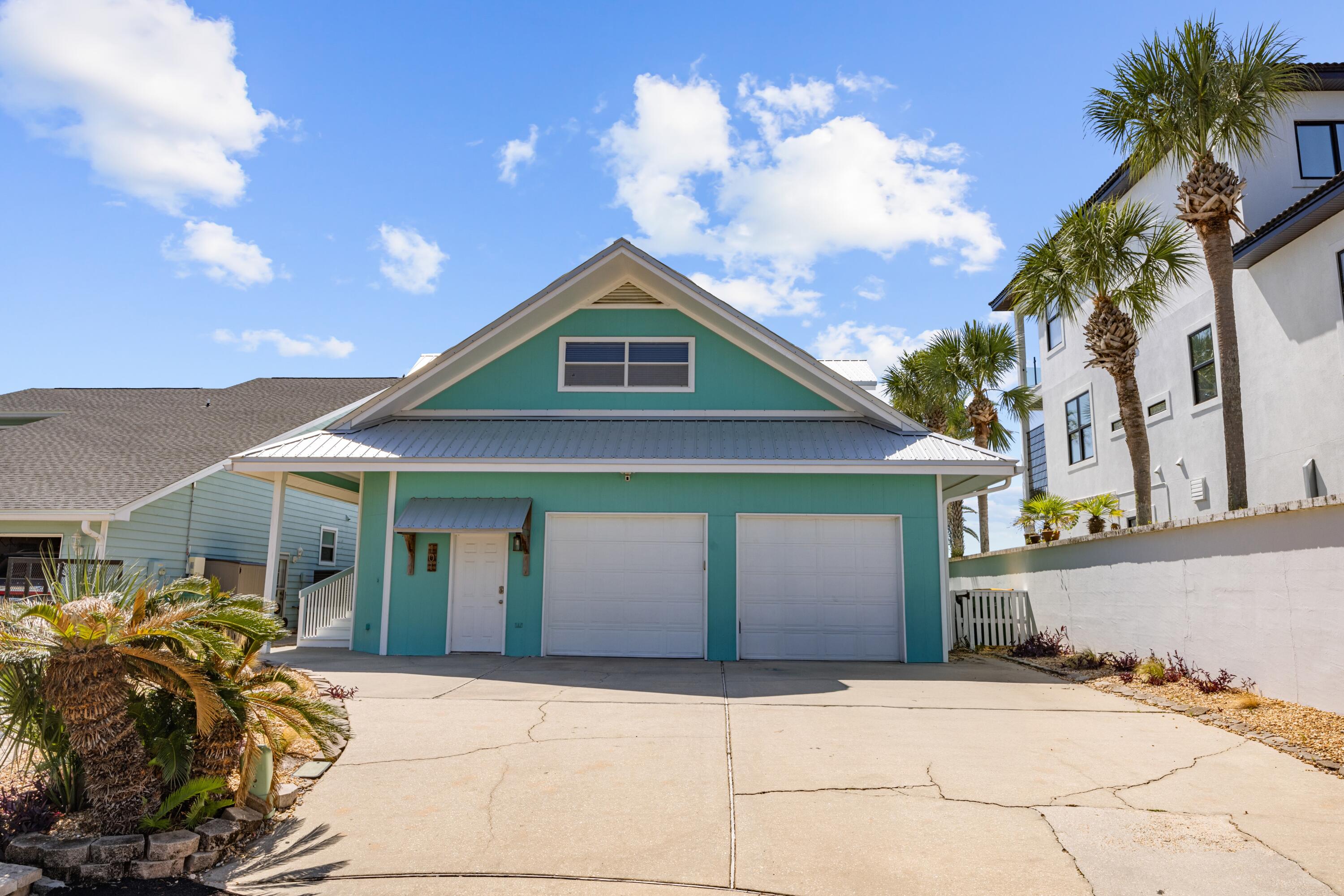 Welcome to 101 Starboard Lane, a beautiful waterfront home in the sought after area of Bal Harbour in Shalimar, FL. The private dock is a standout feature, complete with a protective cover, a 10,000-pound boat lift and nestled in a cove for extra protection. Experience stunning panoramic views of Choctawhatchee Bay and Okaloosa Island/Destin, with Crab Island just a short 15-minute boat ride away, and Norriego Point Beach and the Destin Harbor only 20 minutes by boat. You'll have easy access to a variety of waterfront restaurants and bars along the Destin Harbor, as well as being able to enjoy breathtaking sunsets and watch dolphins parade right from your backyard, deck, dining room, living room and master bedroom! In the backyard, water access into the bay is available via stairs in the rock seawall, and the piling foundation offers massive storage space under the home. This property boasts a brand-new metal roof installed in 2023, ensuring durability and peace of mind. The home is equipped with newly replaced HVAC systems, with the downstairs unit replaced in 2019 and the upstairs unit in 2022, along with a hot water heater updated in 2020. The kitchen is a chef's dream, featuring a large island, granite countertops, a professional-grade 48" Thermador gas stove with six burners and a double oven, dual full-sized sinks, and plenty of natural and recessed lighting. An oversized pantry provides ample storage space. The master suite offers wide waterfront views, multiple closets, and a standalone shower. All first-floor bedrooms come with their own bathrooms, providing convenience and privacy. The spacious laundry room includes storage cabinets, a sink, and counter space for added functionality. The oversized garage is a versatile space, featuring a full bathroom and a walk-in storage closet. On the second floor, you'll find an expansive living room with stunning waterfront views and abundant natural light perfect for private space or an entertaining game room, a guest bedroom with a full bathroom, and a wet bar with storage. Call us for your private tour!