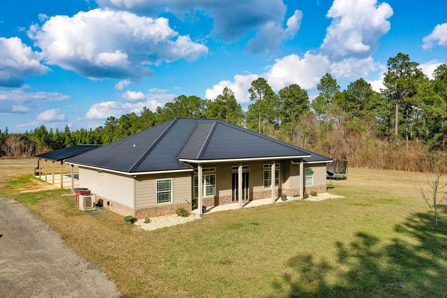 MULTIPLE OFFERS. HIGHEST AND BEST BY 5pm 3/3. Country living at its finest! This beautiful home is located on 10 acres with 2 huge pole barns that are fully concreted with power and water, a huge covered front and back porch to relax, an outside shower, and a POND flooded with timbers that are great for duck, deer, and turkey hunting. What isn't there to love if you are looking spread out on some acreage, a large home with 4 bedrooms, privacy, and looking to plant some roots in the country. Bring the 4 wheelers, farm animals, side by side, tractor, all your hunting gear, and come play! The home offers beautiful wood flooring and tile throughout with NO CARPET.  The kitchen has stainless steel appliances to include a double oven, large walk-in pantry, gorgeous granite countertops, dark stained wood cabinets, tons of cabinet space. and the drawers pull out which makes it easy for organizing, an open floor plan with a stack stoned breakfast bar/island that is great for entertaining. There is a HUGE laundry room that has a freezer, a wash sink, and tons of shelving for extra storage. The bedrooms are large, and it is a split floor plan for privacy. In the living room there is a double tray ceiling with crown molding, surround sound that controls for inside and outside, built-in storage for electric devices, and a gorgeous stack stone fireplace. The master bedroom has crown molding throughout with a coffered ceiling, tons of room, wood flooring, and there is a door that leads to the back porch. The master bathroom has crown molding, dark wood cabinets, granite countertops, a double vanity sink, HUGE walk-in-tiled master shower, a garden tub, and a large walk-in closet. There are so many wonderful features about this home. You don't want to miss this one, schedule your appointment today!