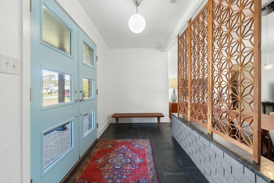 Step into this stunning mid-century modern ranch home in Gulf Breeze, where every detail has been thoughtfully reimagined. This true four-bedroom home has undergone a complete transformation, with walls opened up and spaces redesigned to create an inviting, more open layout. The result is a perfect blend of modern updates and timeless design, with a vintage room divider complete with slate stone flooring in the entryway, multiple hundred-plus year old doors, and a reclaimed wood fireplace mantle among the many amazing touches.  More high-quality materials and upgrades continue throughout, including quartzite natural stone countertops, DOUBLE FIVE-BURNER GAS RANGES AND OVENS(!!!), waterfall kitchen island, and upgraded soft close cabinets with dovetail joints in the kitchen and so much more.  A beautifully added butler's pantry provides extra storage and workspace, making meal prep and entertaining effortless. The master bathroom has also been completely renovated with a curbless entry shower with bench (Schluter Systems), Kohler Purist Collection fixtures, new shower glass and tile, and too many other updates to list.  Most of the home has been rewired and re-plumbed for peace of mind, while natural gas powers the furnace, clothes dryer, hot water heater, and the gas ranges and ovens ensuring efficiency and reliability. A natural gas hookup is also conveniently installed in the backyard, ready for your outdoor grill. The backyard is a true retreat, featuring one of the largest pools in the area, completely renovated in 2022 with a new liner installed in 2023. Surrounding the pool, beautiful pavers, a cozy fire pit, mature trees, lush landscaping, and a drip irrigation system with tree bubblers create a serene outdoor oasis.The curb appeal is just as impressive, with an upgraded Zoysia lawn, a new walkway, and refreshed landscaping. The front yard is equipped with a sprinkler system, and yard service has already been prepaid for fertilization, weed control, and pest management through 2025, keeping your lawn pristine year-round.  All windows and doors are secured with Miami-Dade County-approved metal protection. Additionally, the upgraded electrical system includes a bypass switch for seamless generator hookup in case of an emergency.  This home is a rare find, combining classic mid-century charm with modern conveniences in a prime Gulf Breeze location. Don't miss your chance to own this beautifully renovated property!