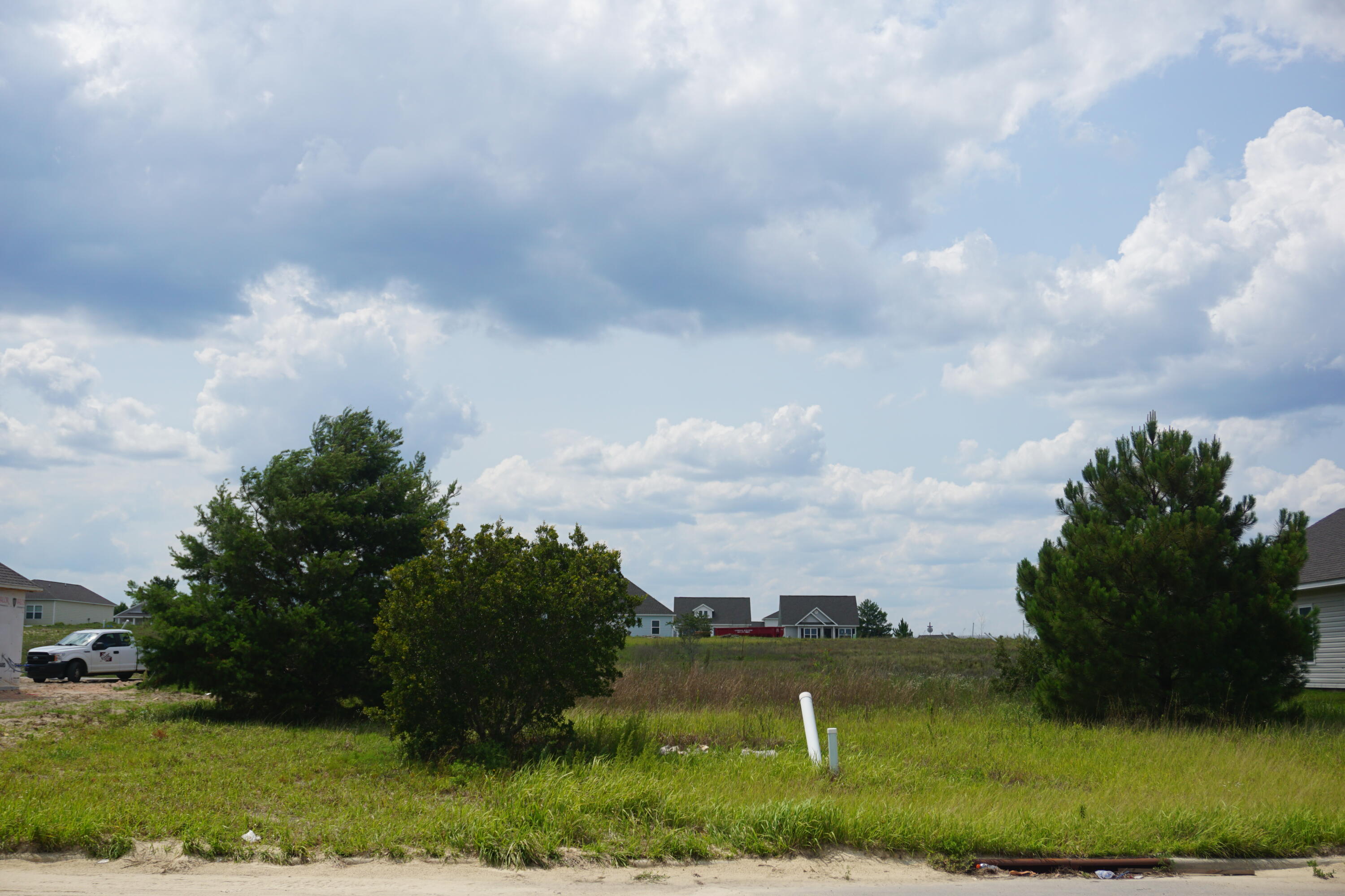 Lake adjacent lot conveniently located off Hwy 331 with quick access to local schools, parks, shopping & restaurants. Only 16 miles from some of the most beautiful beaches in the World! Owl's Head Subdivision offers walking trails, a lake and large green space. Unobstructed lake views! Build your dream home here!