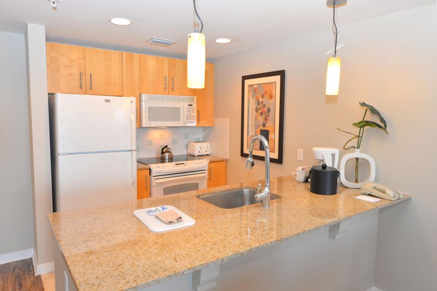 LOWEST PRICED UNIT IN ELATION  SMALL SPACE & BIG STYLE! Totally updated with wood-look plank floor, granite counter tops, quality furniture, & a brand new AC system. This 8th floor condo is one of the few with a Juliet balcony which overlooks a charming courtyard. Located in Baytowne Wharf close to wonderful restaurants, entertainment, & fun shops. Elation owners have used of the heated resort-style pool, fitness center, garage parking, & the Ballyhoo Bar. Take advantage of the many amenities Sandestin Golf and Beach Resort has to offer - miles of white sandy beaches, four championship golf courses, tennis courts, miles of biking/walking paths, bayside marina, fitness center and spa, resort activities, and the pedestrian Village at Baytowne Wharf. You are a short distance from