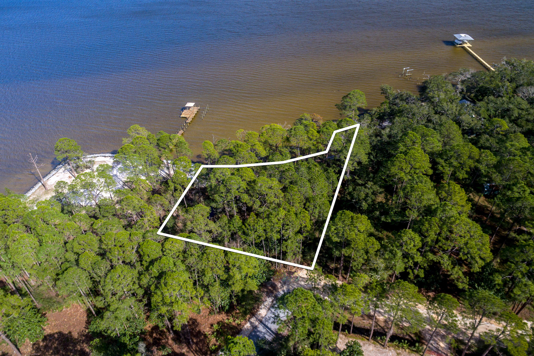 Don't miss out on the opportunity to own this expansive Bay front lot in Santa Rosa Beach! There is 165 feet of water frontage to enjoy the breathtaking views of the Choctawhatchee Bay. Approximate buildable area is just under 7,000 sqft. The lot totals ~.7 acres and boasts mature trees throughout. With 219 foot depth, there's ample room to build your dream house with a pool. Relax after a long day by watching the sunset in a quiet atmosphere, yet still be close enough to enjoy the beaches along 30A and dine at your favorite restaurants. No HOA fees.