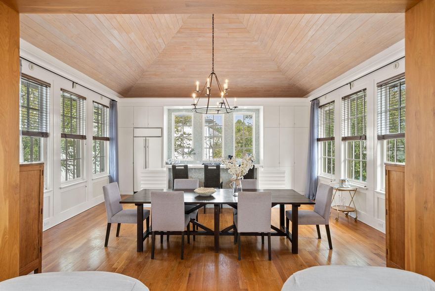 239 Sand Oaks Circle is a thoughtfully designed coastal retreat located behind the gates of Seanest Village in the heart of Seagrove Beach. Positioned prominently facing 30A, yet privately tucked behind a canopy of mature foliage and scrub oak trees, this residence offers the rare balance of convenience and a sense of privacy and calm. Seanest owners and guests enjoy private deeded beach access directly across the street, making Gulf days effortless and exclusive. Designed by architect Eric Watson, the home showcases a blend of Dutch West Indies and Mediterranean architecture often associated with Alys Beach and Rosemary Beach. Built with predominantly concrete block construction, the residence offers excellent efficiency and long-term durability. At just under 2,300 square feet, and spanning across three levels, the layout is both functional and inviting, with two ensuite guest bedrooms privately located on the first floor and a bright open-concept living area on the main level.

The main living level features 10-foot ceilings and ample windows that frame peaceful treetop views and fill the space with natural light. The kitchen is anchored by a timeless custom island and breakfast bar with beveled wood detailing, complemented by Carrara marble countertops and custom cabinetry, all seamlessly connected to the dining and living area. A vaulted ceiling crafted with pine detailing adds warmth and architectural character, while natural heart pine floors run throughout, reinforcing the home's classic coastal aesthetic.

The third floor is dedicated to the primary suite, with vaulted ceilings, a spa-like bath with soaking tub and walk-in shower, a spacious walk-in closet, and a private balcony with Gulf views.

Outdoor living includes a private low maintenance yard with fire pit area, multiple balconies to take in coastal breezes and the vibrance of 30A, and an enclosed courtyard shaded by mature trees for a cool and secluded space ideal for relaxing or entertaining. Additional features include a 3-stop elevator and a two-car garage with Tesla charging station. Ideally located a near Seaside and the shops and dining at Greenway Station, Seanest Village is uniquely positioned between Point Washington State Forest and Highway 30A, offering a natural buffer of privacy while keeping the best of 30A close at hand. 