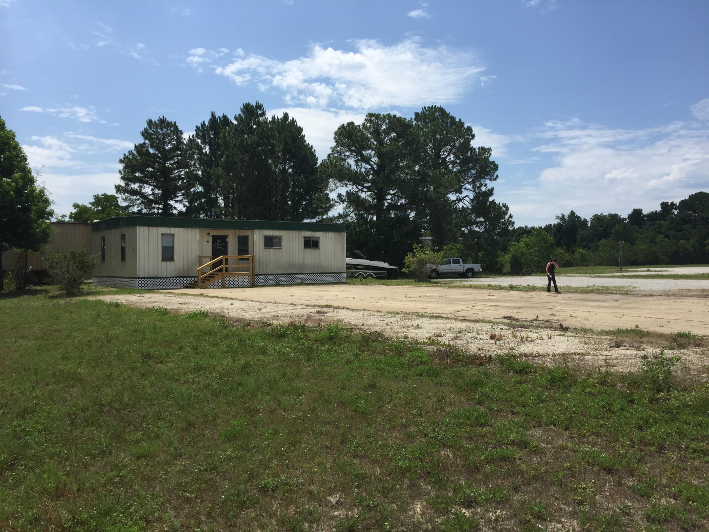 Fenced in lot great for a storage lot, drop lot, contractors office etc. There is building on the property that has 3 offices, 1 restroom, reception area, coffee bar, and extra storage.