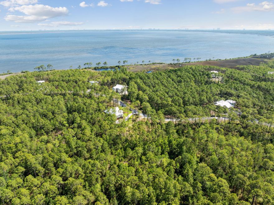Seize the opportunity to build your dream home in the exclusive, gated RiverCamps community in Panama City Beach. This spacious 0.55-acre lot has been professionally cleared and comes with HOA-approved architectural plans and completed soil testing--saving you months of preparation and expense. Nestled within a 1,500-acre waterfront sanctuary bordered by West Bay, Crooked Creek, and the Intracoastal Waterway, RiverCamps offers a unique blend of privacy and natural beauty. Over 1,000 acres are dedicated to conservation, ensuring a serene environment for residents. Outdoor enthusiasts will appreciate the community's amenities, including a boat ramp, day-use slips, dry-boat storage, and access to kayaks, canoes, and paddleboards. Scenic trails wind through the community, perfect for walking or biking. A new pool, pool pavilion, fitness center, and River House amenities are planned for construction in 2025, further enhancing the lifestyle offered at RiverCamps.
Conveniently located just minutes from Northwest Florida Beaches International Airport, Pier Park, and the white-sand beaches of the Gulf, this lot offers both tranquility and accessibility. Whether you're a builder or a homeowner ready to construct a custom retreat, this property is primed for immediate development.