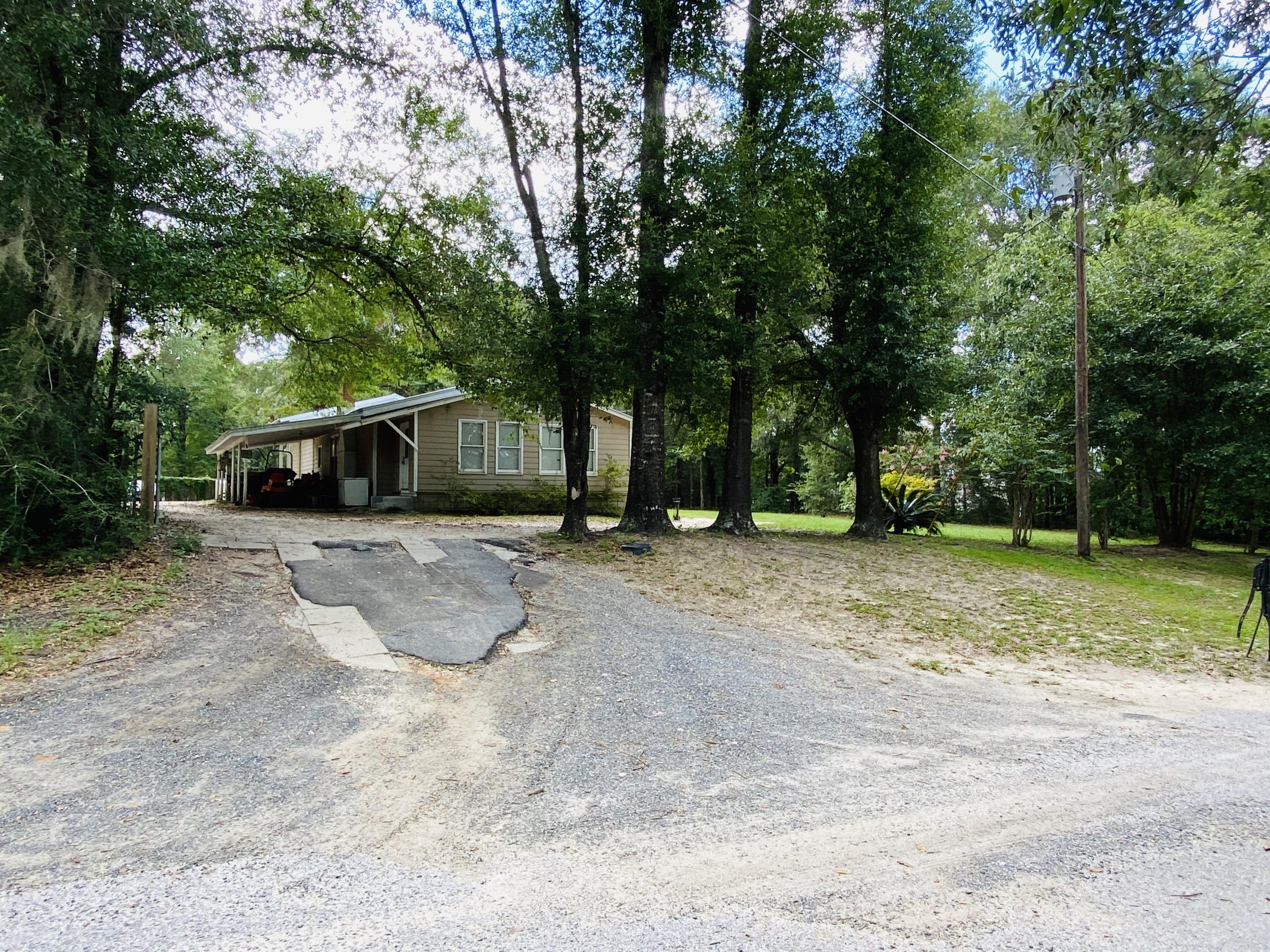 Over 2 acres of beautiful property. Home has 2 large bedrooms. Wood ceilings and renovated kitchen! Open living and dining area. Huge laundry area with 1/2 bath. Covered porch to enjoy the peace and quite. Home and large workshop. Lots of storage.