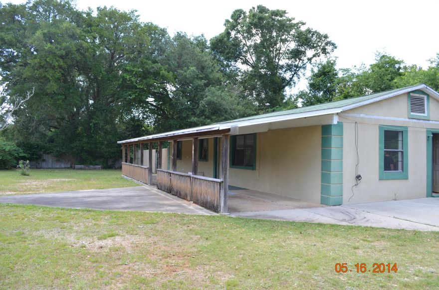 Nestled in the heart of Pace and just minutes to just about everything this home is a handyman's dream. Just a little bit of elbow grease and this home will shine. This country styled home has a large open porch, privacy fenced back yard, and powered workshop. Inside this home you will find tongue and groove wood on some walls, a large stand up bar, and beamed ceilings. This home has 4 bedrooms and 2 baths as well as in door laundry. Priced to sell this one will not last long!