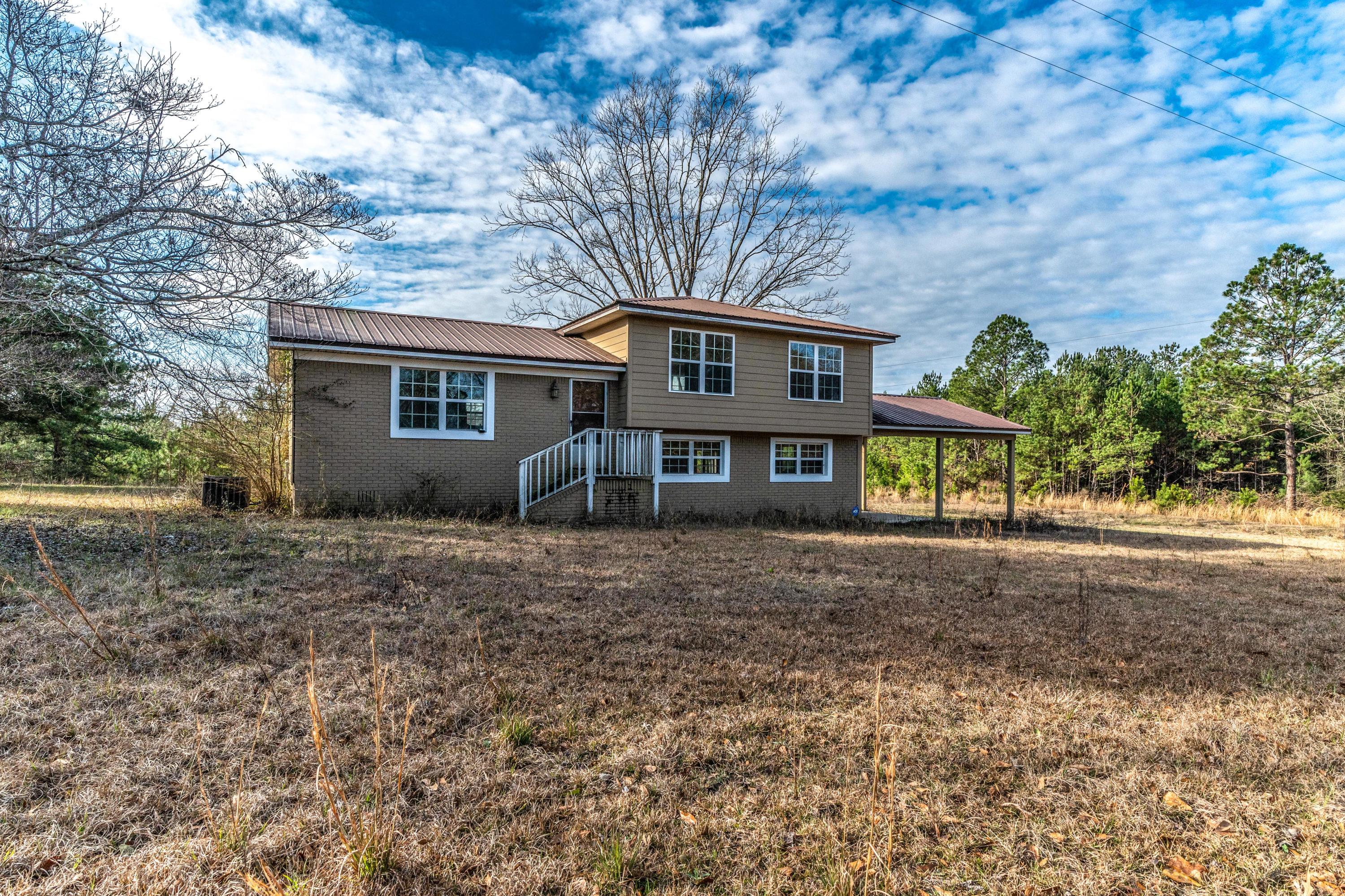A few years ago this home was completely remodeled inside and has been maintained well by the owner. Wood laminate floors and crown molding throughout the whole house besides tile in the bathrooms. The exterior has high efficiency windows and a metal roof. Also a nice two car carport and in the back a 12x22 deck. All sitting on 17.37 acres of land. Come check this great home out today and don't miss out.