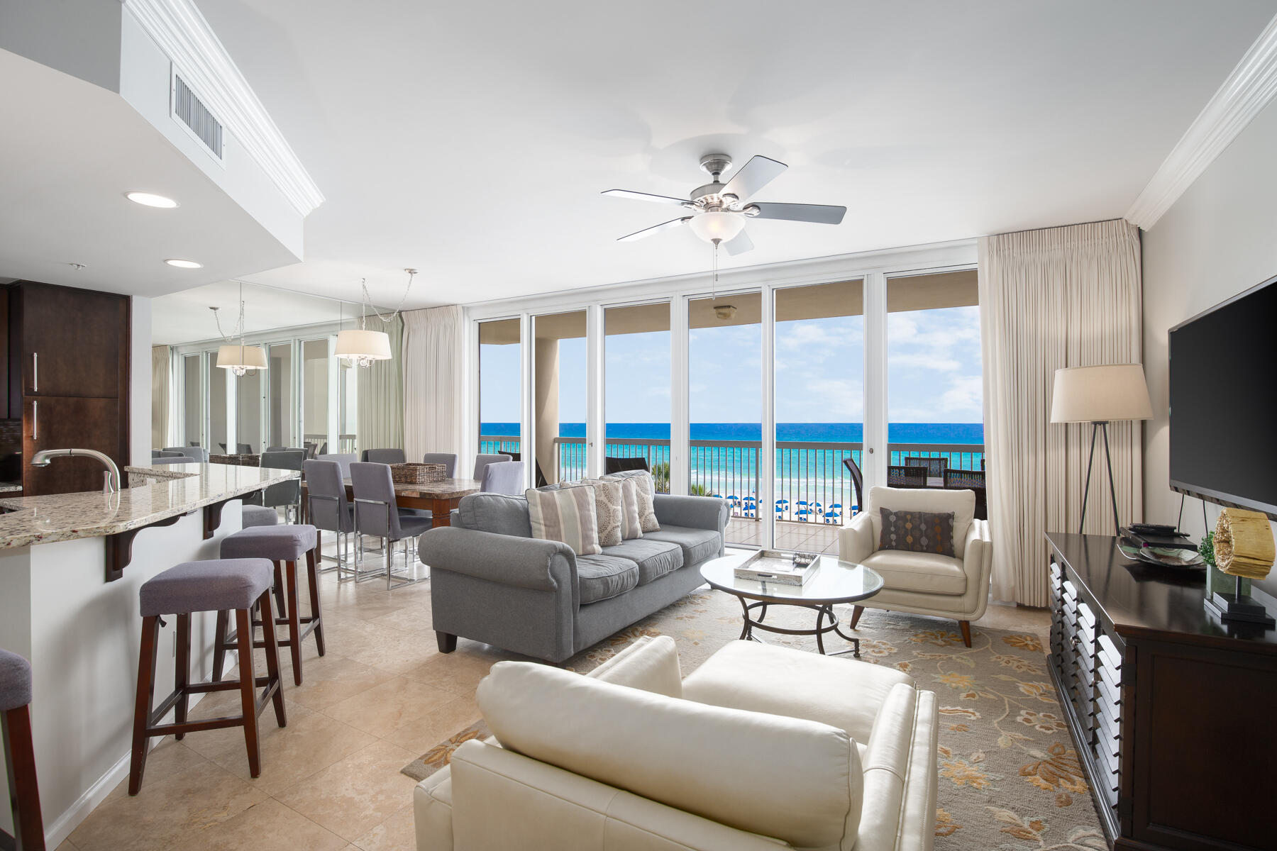 A perfectly positioned 4th Floor Luxury Beach Front Condo! Upon entering, you will be amazed at the Floor to Ceiling windows and unobstructed views of the Emerald Coast. The Balcony is spacious enough to accommodate both lounging and an outdoor dining area. This is 3-bedroom, 3-bathroom unit which also comes with a covered assigned parking space. The open floor plan allows for views from the kitchen, living and dining areas. Featuring a Beach Front Main Suite with direct access to the balcony and large windows which offer stunning views from the bed and bathroom areas. It also offers a seating area, walk in closet and an en-suite bathroom with shower, separate tub & double vanity. Two more bedrooms and bathrooms plus a full-size laundry area complete this floor plan. Sold fully furnished