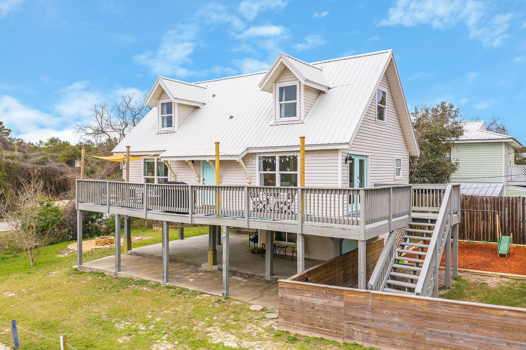 Welcome to 307 Circle Drive, located on the highly desired west end of Panama City Beach! Just a short 3-5 minute walk to the white sandy beaches! This 3 bedroom 2.5 bathroom raised stilt home provides over 1400 square feet of heated/cooled living. Additionally, it offers over 400 sq ft of deck and 1400 sq ft of under home entertaining space! Also to include lower level storage space for all of your bikes, beach toys, tools and so much more! After a long day at the beach, enjoy starting an outdoor fire in the firepit and gather around to tell campfire stories. Sold fully furnished, this turnkey beach house is ready to enjoy with the family. Add to your portfolio turn this investment into a cash flowing asset! Currently used as a short term rental. 2023 rental numbers can be shared upon request.
Call today to schedule your private showing and see for yourself the endless opportunities this home can provide!