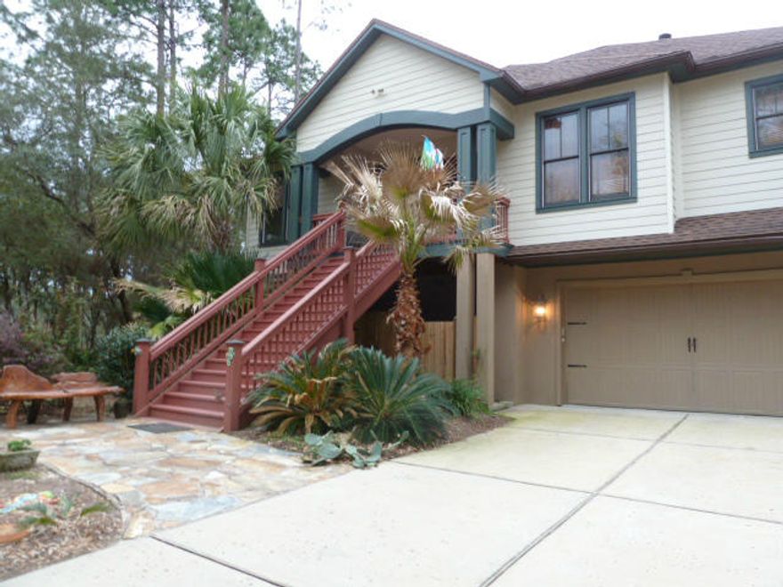 Overlooking the peaceful landscape of Mallet Bayou, this beautiful two story home with elevator is a warm and inviting place to call home. The main living areas are located on the second story and include a kitchen with granite countertops and breakfast bar, a dining area, living room with built in shelving and custom fireplace, a bedroom/office, and a separate master suite with his and her's walk-in closets. Beautiful hardwood and travertine flooring. Use the elevator or stairs to reach the story below, complete with another kitchenette, living room, two bedrooms, and full bath. Garage space includes a Safe Room. A gorgeous screened porch spans the back of the second story and offers an incredible view of the bayou, with stairs leading down to the beautiful brick courtyard.