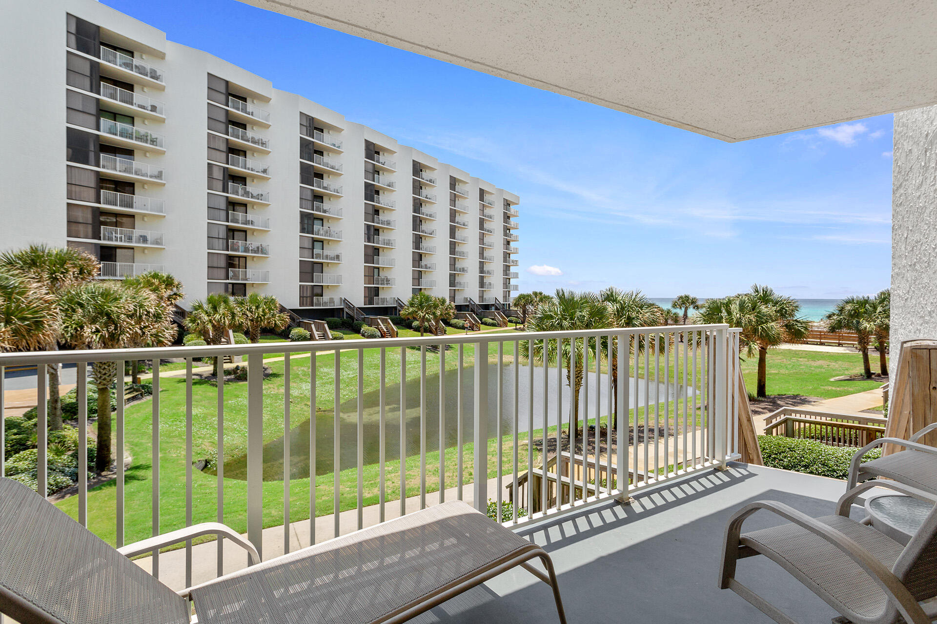 This beautiful, first-floor beachfront rental condo is a must-see. Enjoy a private staircase from the patio down to the lush lawn centered on a lagoon studded with palm trees and a walkway over to the sugary beach. Located in the highly sought-after building of Mainsail Resort, this comfortably furnished and inviting two-bedroom vacation rental is a turn-key rental investment! With over fifteen acres of lush landscaped grounds, an array of amenities such as private beach, two swimming pools, a hot tub, wading pool for kids and so much more. Don't forget about the fitness center overlooking the pool which includes showers, dressing areas, and a sauna! There are also four tennis courts, a basketball court, and a shuffleboard court, all lighted for night play.

An arcade game room is provided for kids when they're not splashing around at the beach or in the pool.

Mainsail 146 features a split floor plan design with all three guest quarters in different locations. This provides a sense of privacy for all traveling party members. Two of the bedrooms include ensuite baths, while the other shares a hallway bath that serves as a convenient powder room. The living area has a bright corner window framing views of the glittering gulf, along with sliding glass doors leading out to the beach-view balcony. Raised white Adirondack chairs and a table invite you to experience the stunning seascape while enjoying your favorite libations. The living room has vibrant, chic, coastal-styled furnishings, including a festively striped couch, a love seat, and two plush blue armchairs facing a large creamy white entertainment cabinet with decorative art and a flatscreen TV. The couch also converts into a queen-sized sleeper sofa for added bedding if needed. A stylish white cottage-style dining area nearby includes ladder-backed chairs beside a mottled granite-topped bar with wide stools for additional wining and dining. A convenient wet bar has a wine cooler and sink for serving savory drinks and snacks, while the primary kitchen features brushed stainless steel appliances, providing everything needed to create a fun family feast.
The primary bedroom has white, stately cottage-styled furnishings with a king-size bed, direct balcony access, and a private bath with dual vanity sinks and a separate tub-shower combination. Both guest bedrooms include queen-size beds, while one also boasts an extra twin-size trundle bed. Each has a sunny window, flatscreen TV, and coastal-inspired decor.

Mainsail's prime Miramar Beach location is a short distance from popular gulf-front restaurants, beach bars, grocery stores, area attractions, and shopping, including one of the nation's largest discount designer centers, Silver Sands Premium Outlets. Restaurants with bars, specialty shops, boutiques, fine clothiers, and a movie theater are minutes away at the swank Sandestin Golf & Beach Resort town center of Grand Boulevard. The enchanting New Orleans French Quarter-inspired Village of Baytowne Wharf is also at Sandestin on the bayfront, with delicious restaurants, fun bars with live music, unique family amusements, exciting year-round festivals, outdoor concerts, and vibrant seasonal firework displays.