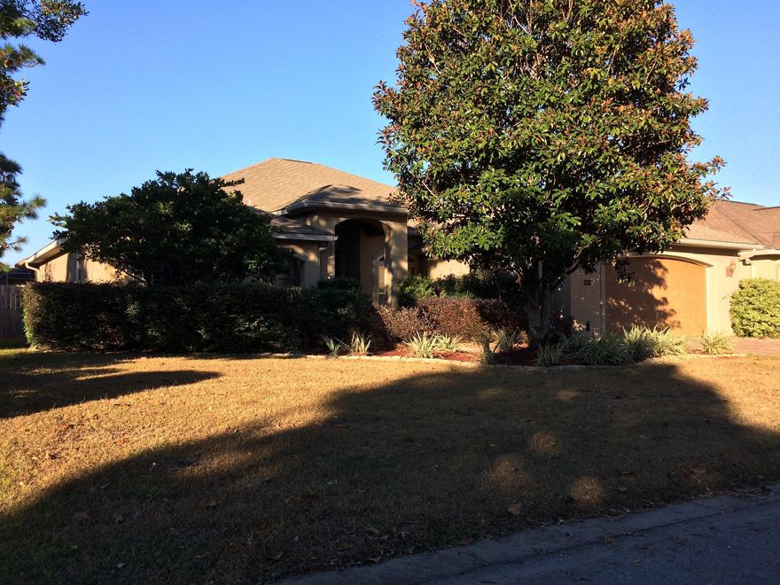 Your long house hunt is over! You absolutely must see this gorgeous executive style home. This stunning 4 bedroom, 3 full bath executive home offers split floor plan with 11 ft ceilings, 2 living areas, gas fireplace, large Kitchen with beautiful cherry cabinets, granite counter tops, walk in pantry, breakfast nook, breakfast bar and formal dining room. Double doors invite you into the Master suite, with trey ceiling. Master bath has his & hers walk in closets, separate vanities, separate shower and jetted soaking tub. 2 bedrooms share a jack n jill bathroom. 4th bedroom is private with another full bath. A perfect guest or in law suite. The screened lanai with pavers and 7 person hot tub extends the luxurious living space. Extra wide garage and fully pavered, extra wide driveway